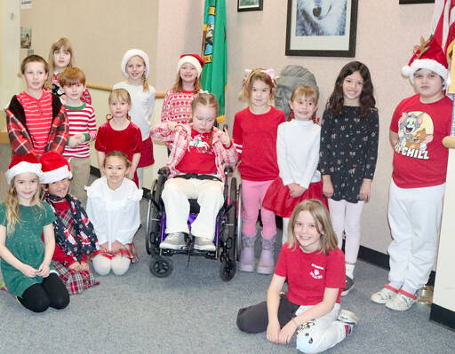 Jefferson Elementary School in Port Angeles designated Thursday dress up like a candy cane day. Back row, from left to right, they are: Wyatt Farman, Ari Ownby, Tayo Murdach, Chloe Brabant, Peyton Underwood, Lola Dixon, River Stella (in wheelchair), Fenja Garling, Tegan Brabant, Odessa Glaude, Eastyn Schmeddinger-Schneder. Front row: Ellie Schneddinger-Schneder, Cypress Crear, Bryn Christiansen and Evelyn Shrout. (Dave Logan/for Peninsula Daily News)