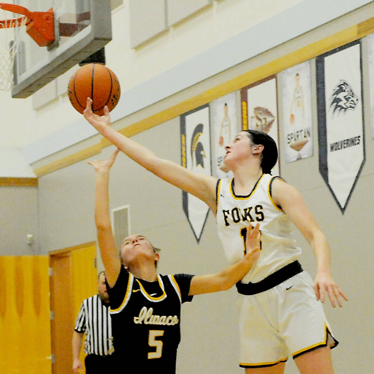 Chloe Gaydeski of Forks battles for a rebound over Ilwaco’s Madison Smolorak on Monday in Forks. The Spartans won their Pacific 2B League opener 63-23. (Lonnie Archibald/for Peninsula Daily News)