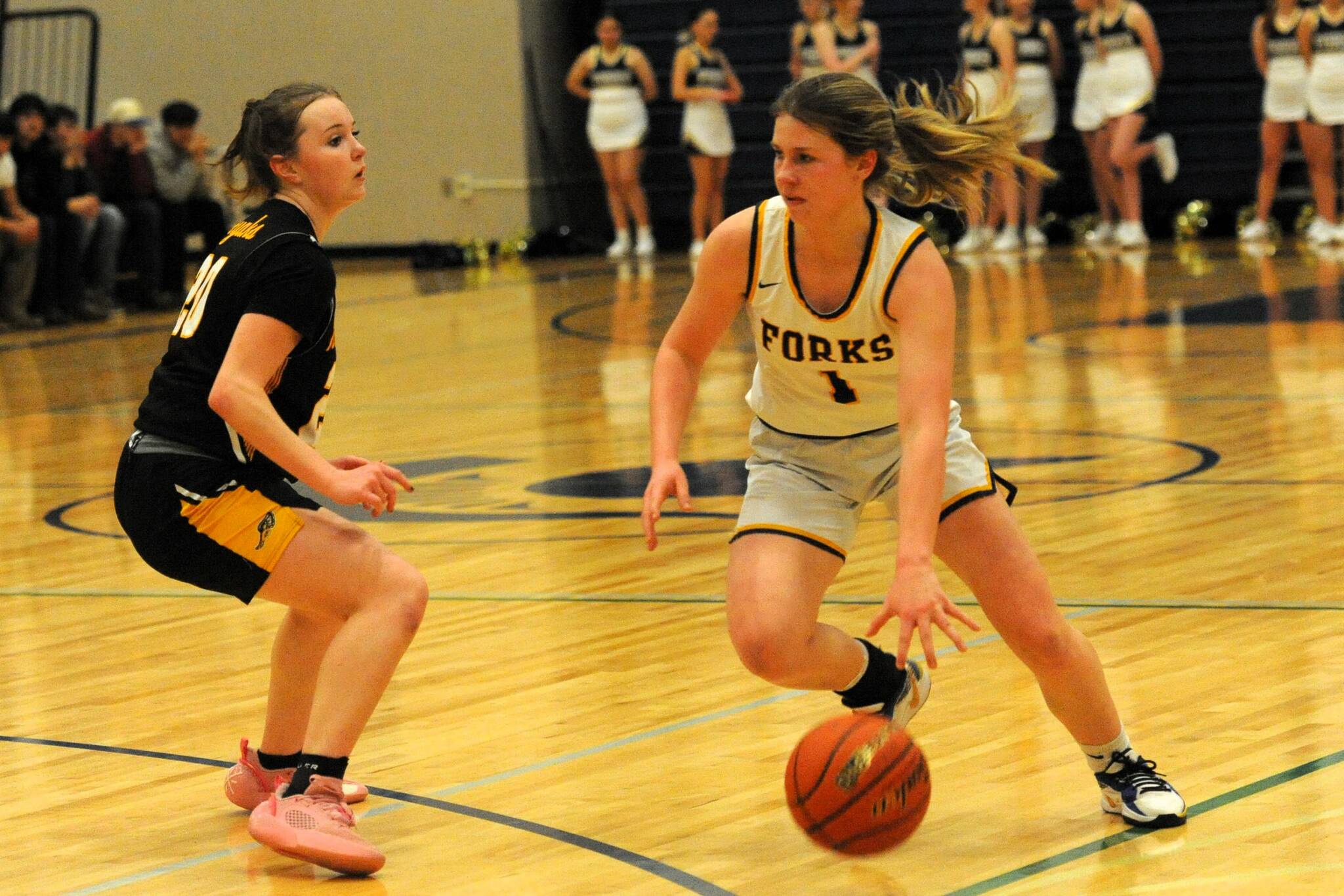Lonnie Archibald/for Peninsula Daily News
Forks’ Bailey Johnson drives against North Beach’s Elka Cox during the Spartans’ 60-18 win Wednesday night at the Spartans gym.