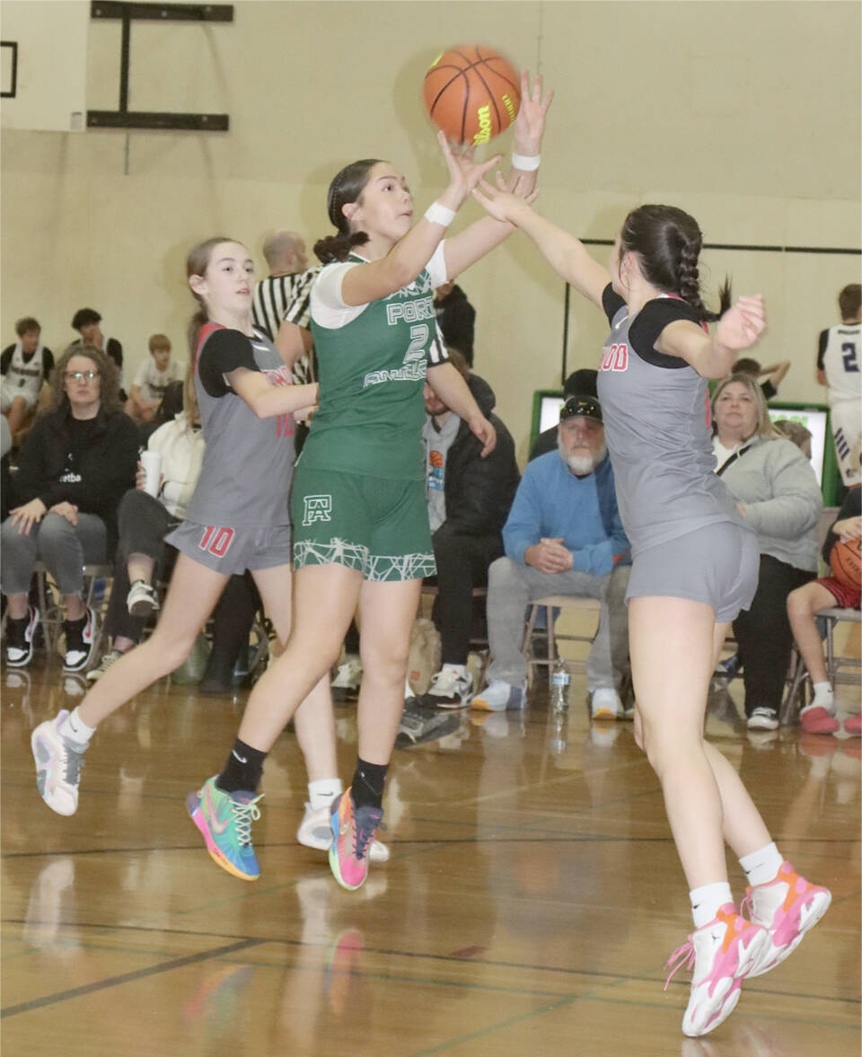 The Martin Luther King Jr. basketball tournament was held this weekend at various gyms around Port Angeles. A total of 70 teams, with boys and girls from fourth through eighth grade, and from as far away as Stanwood, Lakewood and Ephrata competed in the two-day event. Here, Helen Martin of the Port Angeles seventh-grade girls team, made up of players from Stevens Middle School, Queen of Angels and Neah Bay, goes up against Stanwood. (Dave Logan/for Peninsula Daily News)