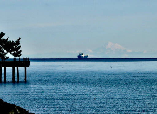 A ship passes by Mount Baker in the Strait of Juan de Fuca as seen from the Port Angeles City Pier on Wednesday morning. The weather forecast continues to be chilly this week as overnight temperatures are expected to hover around freezing. Daytime highs are expected to be in the mid-40s through the weekend. (Dave Logan/for Peninsula Daily News)