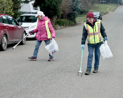 Dona Cloud and Kathy Estes, who call themselves the “Garbage Grannies,” volunteer each Wednesday to pick up trash near their neighborhood on the west side of Port Angeles. They have been friends for years and said they have been doing their part to keep the city clean for five years now. (Dave Logan/for Peninsula Daily News)
