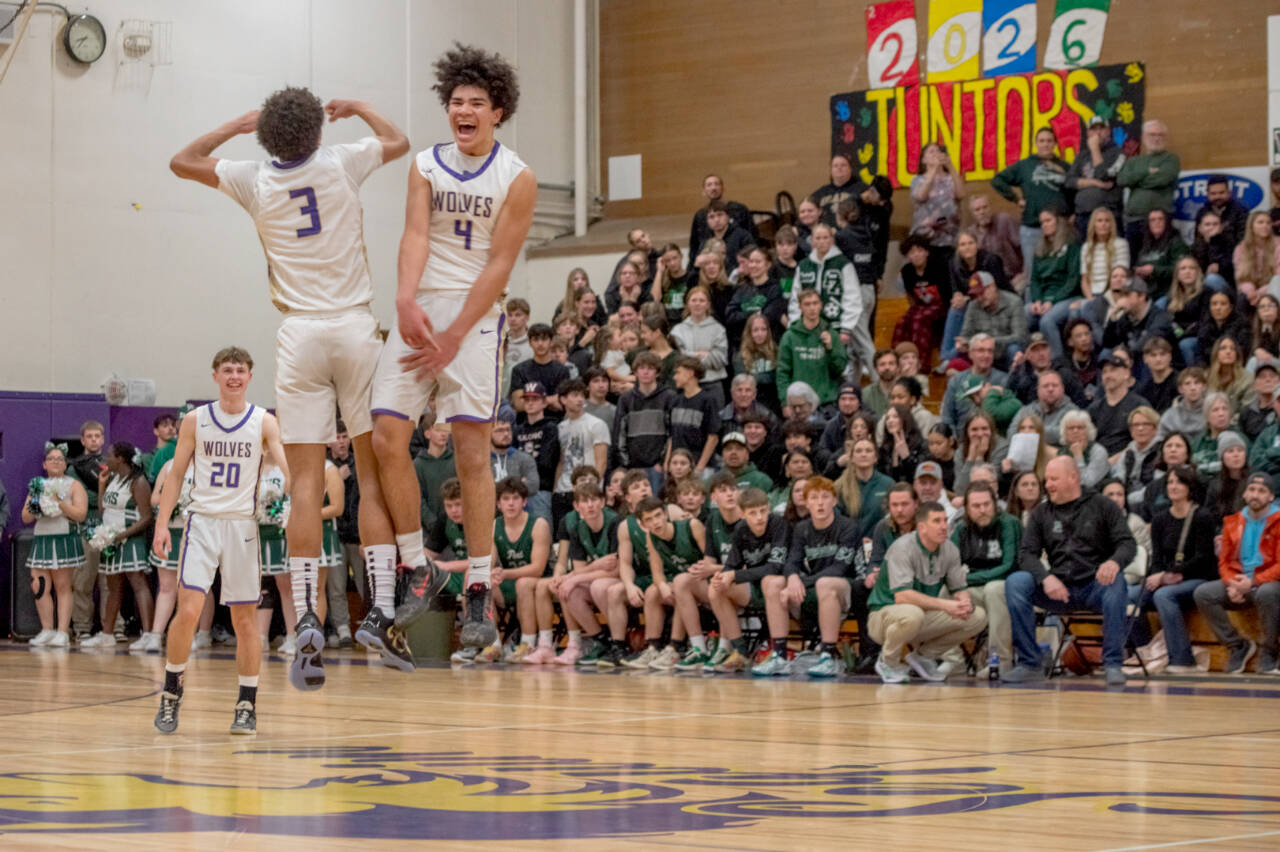 Emily Matthiessen/Olympic Peninsula News Group
Sequim's Jericho Julmist, right, and Solomon Sheppard celebrate the Wolves' come-from-behind victory over rival Port Angeles on Friday night.