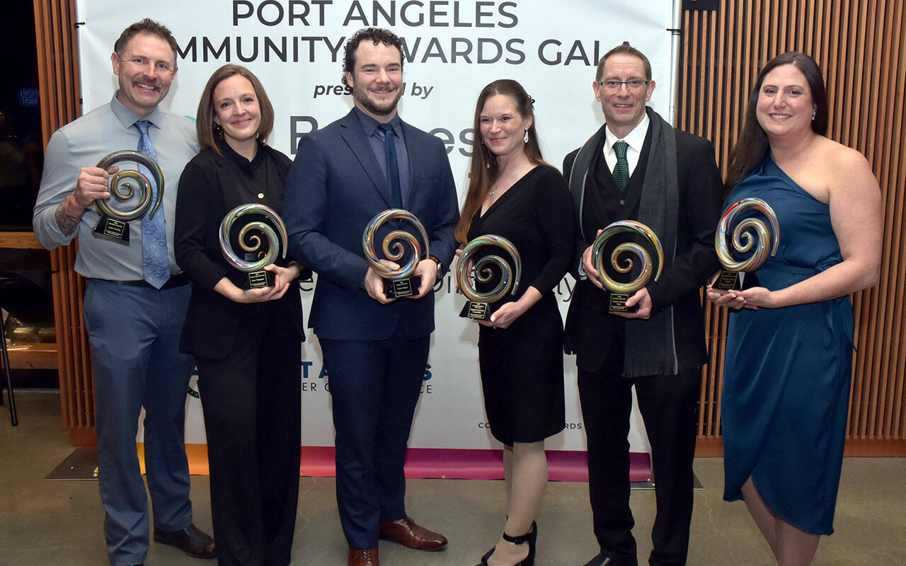 Recipients of Port Angeles Community Awards gather after Saturday night’s awards gala at Field Arts & Events Hall in Port Angeles. Winners were, from left, counselor Jason Gooding of the Port Angeles School District, educator of the year; Rose Thompson, executive director of the Dungeness Crab Festival and owner of Fogtown Coffee Bar, young leader of the year; Danny Steiger, CEO of Lumber Traders Inc., citizen of the year; Alicia Campion, administrator of Ridgeline Homecare Cooperative, emerging business of the year; Don Droz, general manager of Swain’s General Store, business of the year; and Elisia Anderson, executive director of First Step Family Support Center, organization of the year. (Keith Thorpe/Peninsula Daily News)