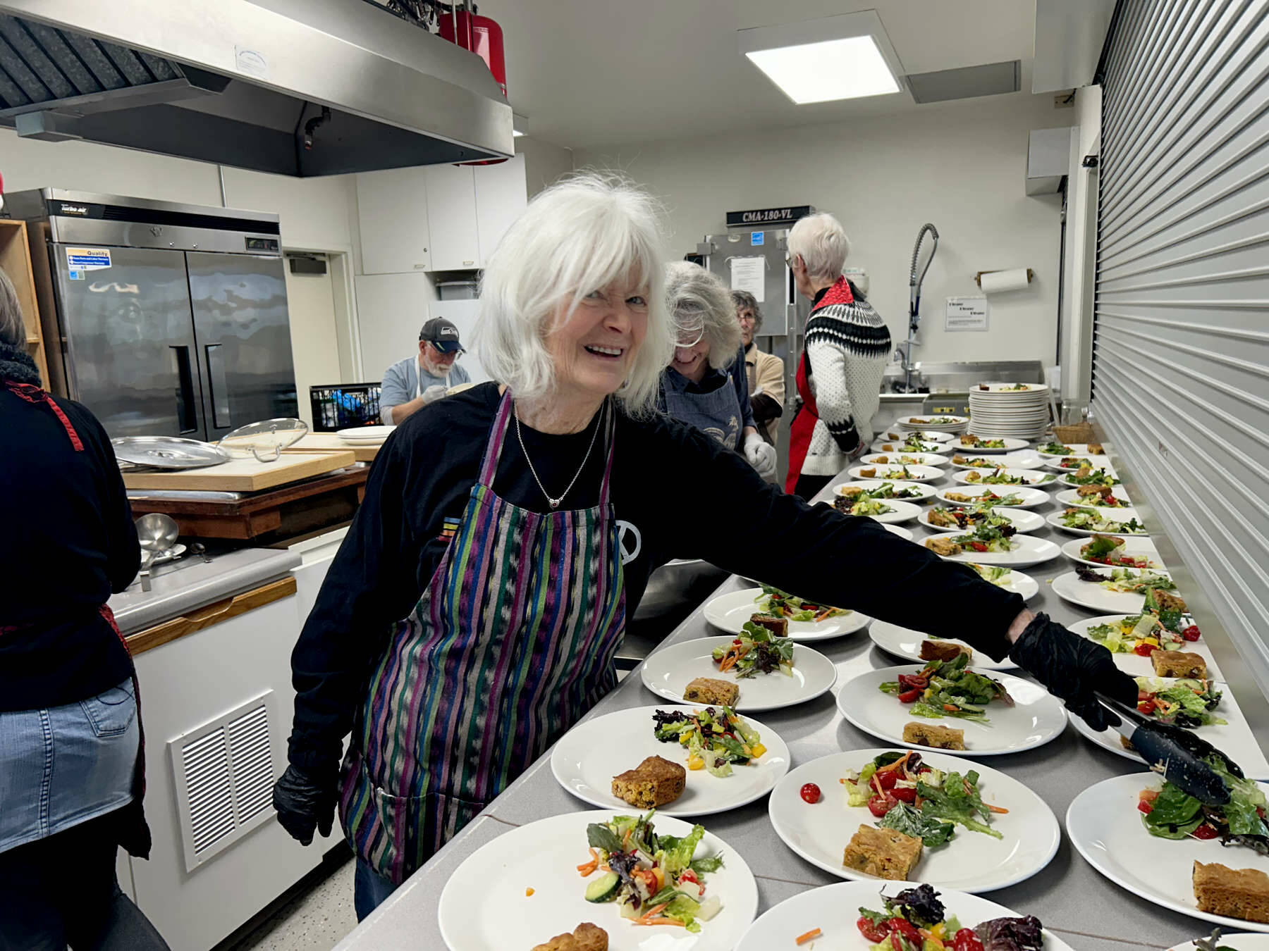 Kathy Cruz/Olympic Peninsula News Group
Mary Montgomery-Crumley dishes up helpings of salad at “Soup’s On.” Lunch also included a biscuit, two versions of minestrone soup, one vegetarian, one with chicken, and chocolate chip butterscotch bars.