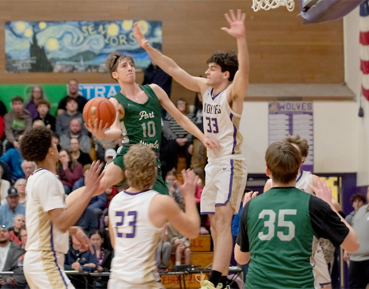 Port Angeles’ Keatyn Hoch (10) goes up for a basket against the defense of Sequim’s Jamison Gray (33) on Friday night in Sequim. The Wolves rallied in the fourth quarter to win 58-49. (Emily Mathiessen/Olympic Peninsula News Group)