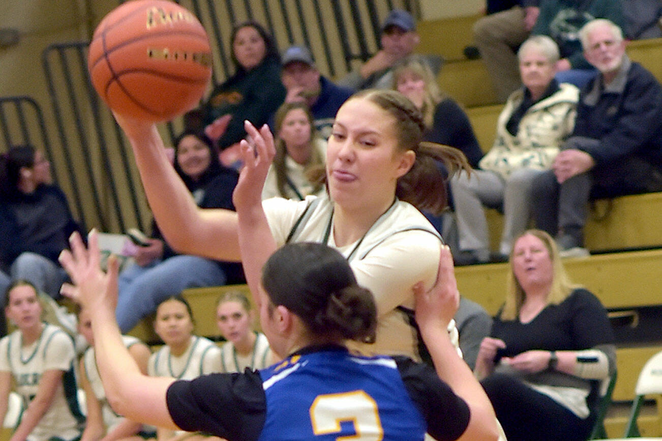 KEITH THORPE/PENINSULA DAILY NEWS
Port Angeles' Cayleith Alward, top, passes over the head of Bremerton's Tiana Barber on Friday night on the Port Angeles home court.