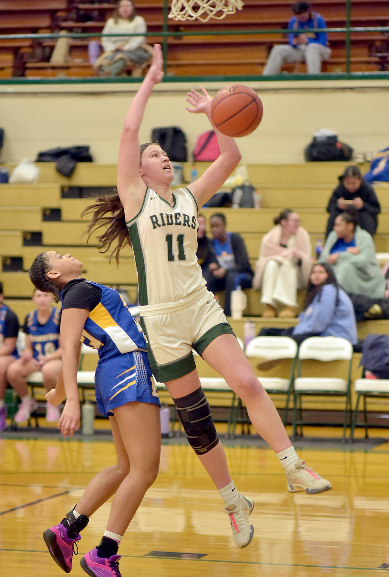 KEITH THORPE/PENINSULA DAILY NEWS Port Angeles’ Lindsay Smith goes up and over Bremerton’s Siara Wilson during Friday night’s game at Port Angeles High School.