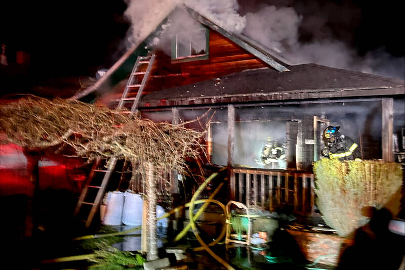Firefighters respond to a house fire at West Sixth Street and Cherry Street on Friday in Port Angeles. (Port Angeles Fire Department)