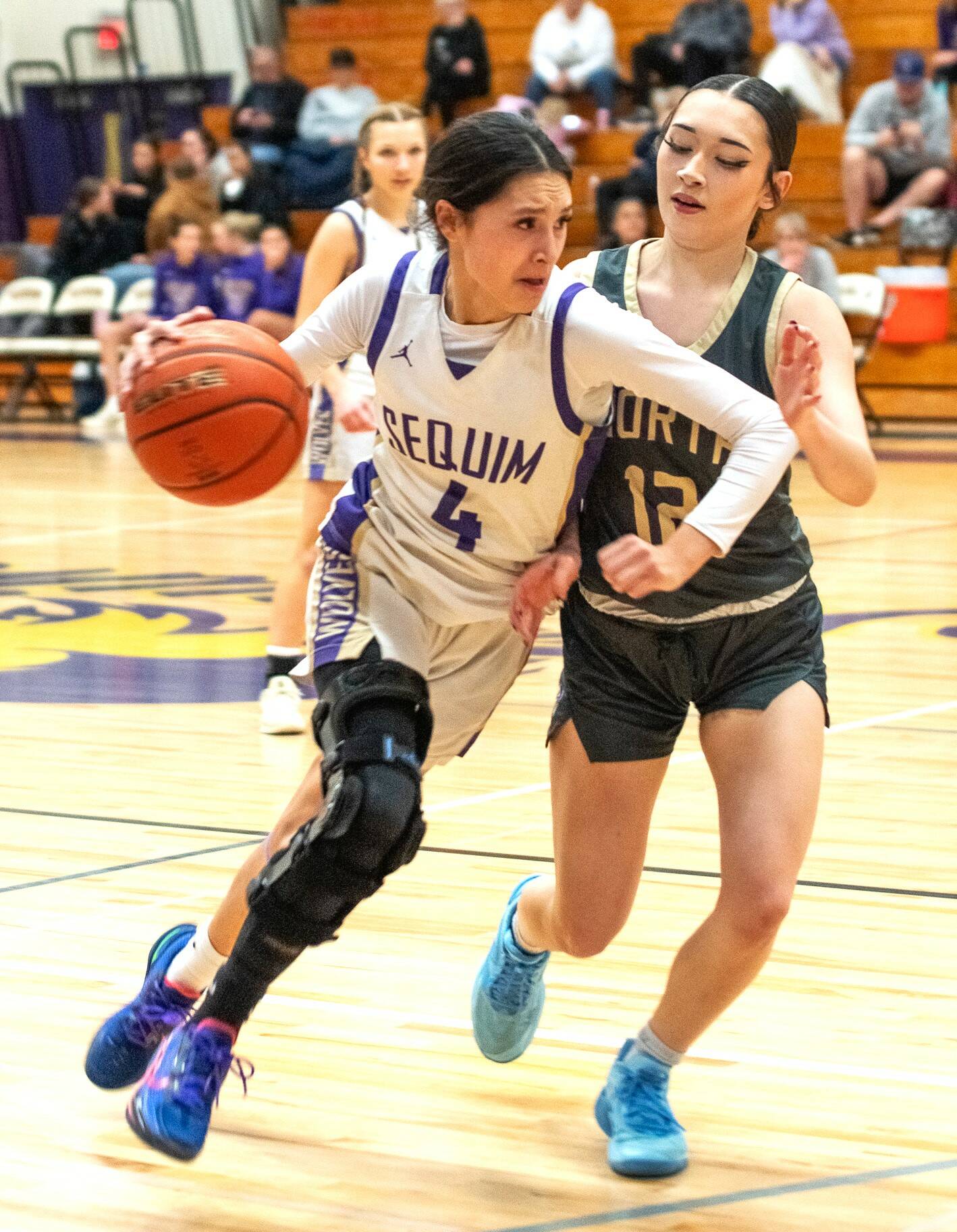 Sequim’s Gracie Chartraw dribbles against North Kitsap on Friday in the Wolves’ final home game of the year. (Emily Mathiessen/Olympic Peninsula News Group)