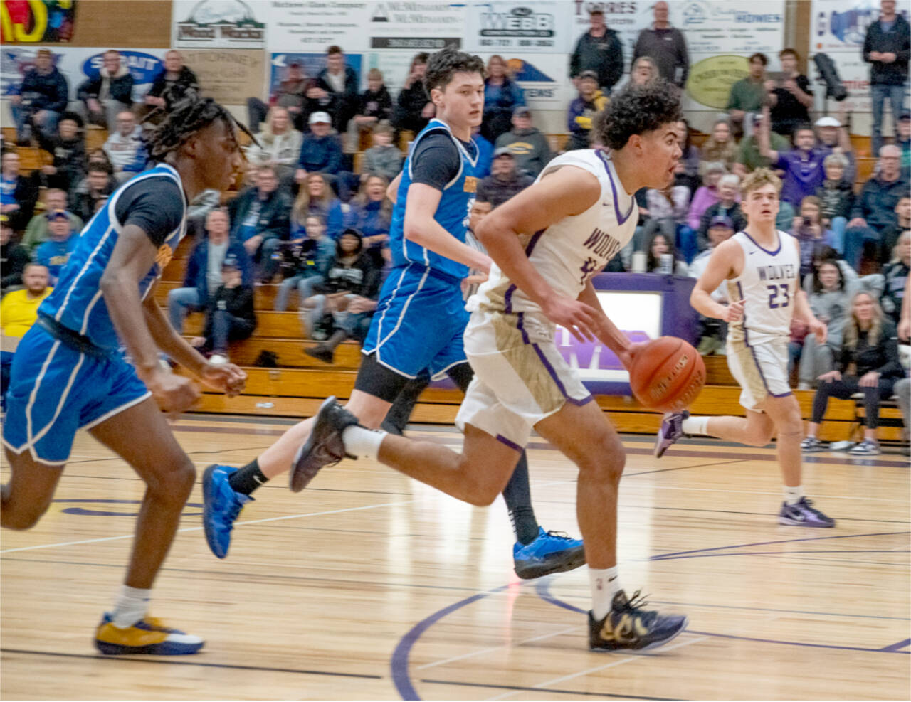 Sequim’s Jericho Julmist drives to the basket against Bremerton in Sequim on Monday night. In on the play is Sequim’s Zeke Schmadeke. Sequim won 66-61 to earn a share of the Olympic League title. (Emily Mathiessen/Olympic Peninsula News Group)