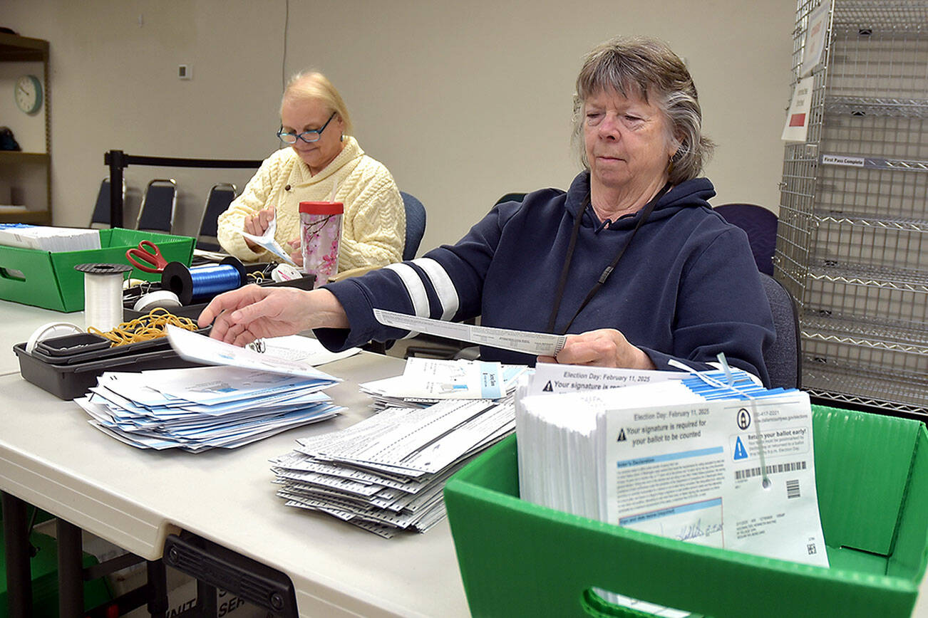 KEITH THORPE/PENINSULA DAILY NEWS
Clallam County election workers Neva Miller, right, and Debbie Kracht, both of Sequim, open election ballots on Tuesday at the courthouse in Port Angeles.