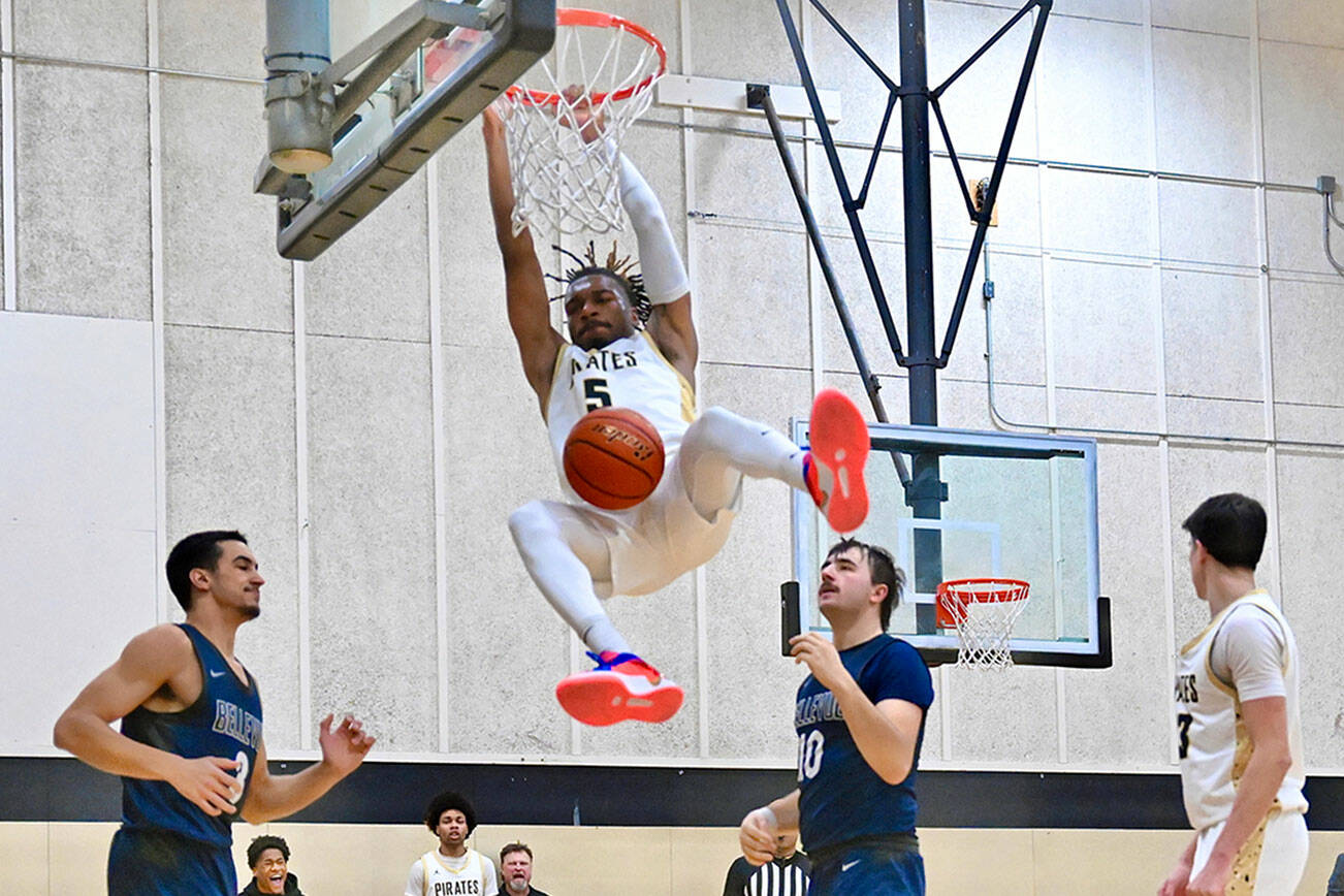 Jay Cline/Peninsula College Athletics
Peninsula College's Cinco McNeal completes a slam dunk during the Pirates 75-74 overtime loss to Bellevue on Wednesday.