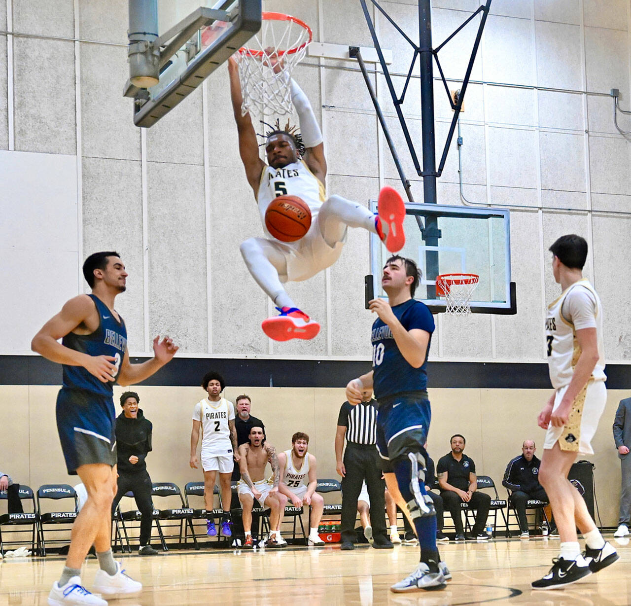 Jay Cline/Peninsula College Athletics Peninsula College’s Cinco McNeal completes a slam dunk during the Pirates 75-74 overtime loss to Bellevue on Wednesday.
