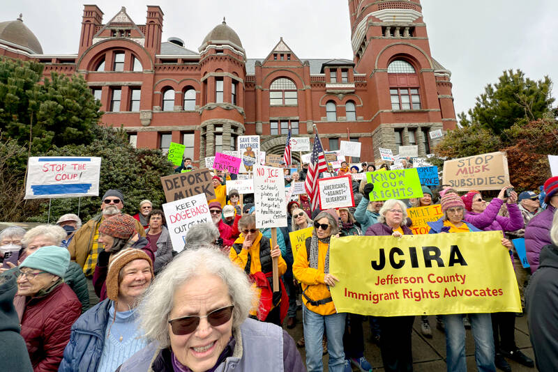 About 800 people from Jefferson and Clallam counties spill out from the steps of the Jefferson County Courthouse onto Jefferson Street in Port Townsend on Monday to take part in a National Day of Protest organized by the 50501 Movement, which stands for “50 protests, 50 states, 1 movement.” (Steve Mullensky/for Peninsula Daily News)
