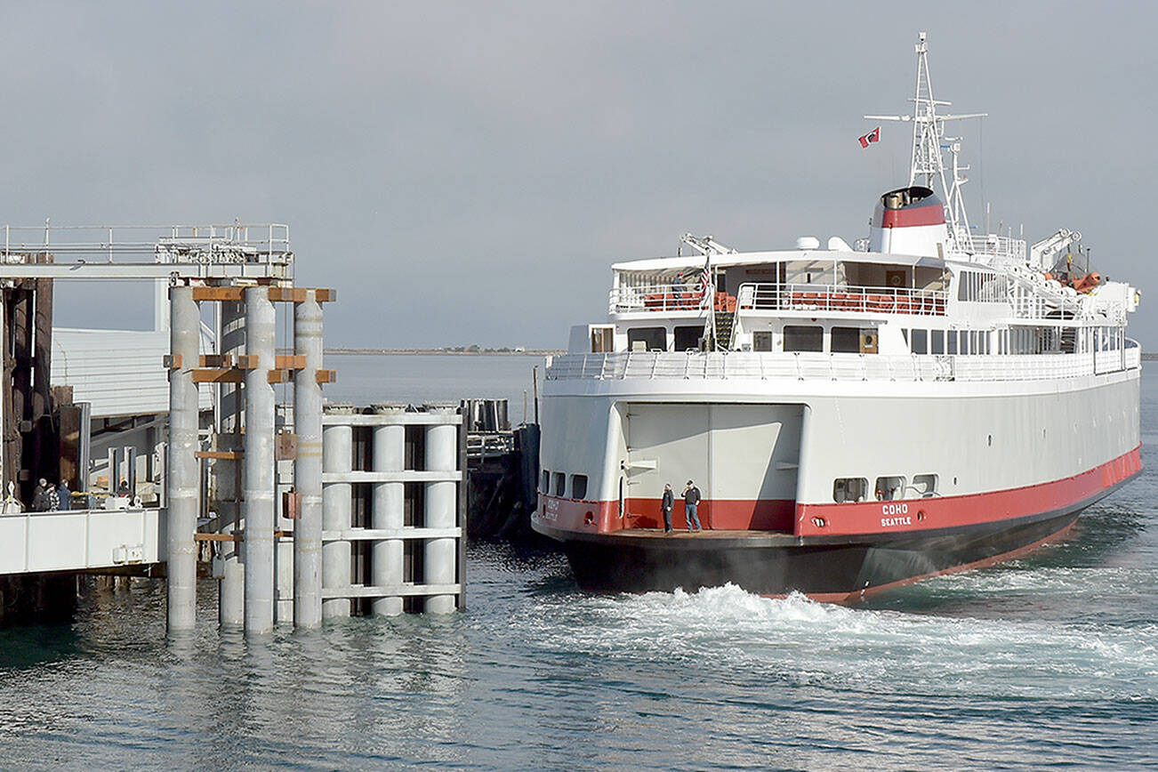 The ferry MV Coho backs into its landing after returning to Port Angeles on Tuesday following annual dry dock and maintenance in Anacortes. During the maintenance period, extensive work was performed on the dock, including replacement of a wing wall used to steer and secure the vessel during loading and unloading of cars and passengers. The ferry is scheduled to resume daily service between Port Angeles and Victoria on Thursday. (Keith Thorpe/Peninsula Daily News)