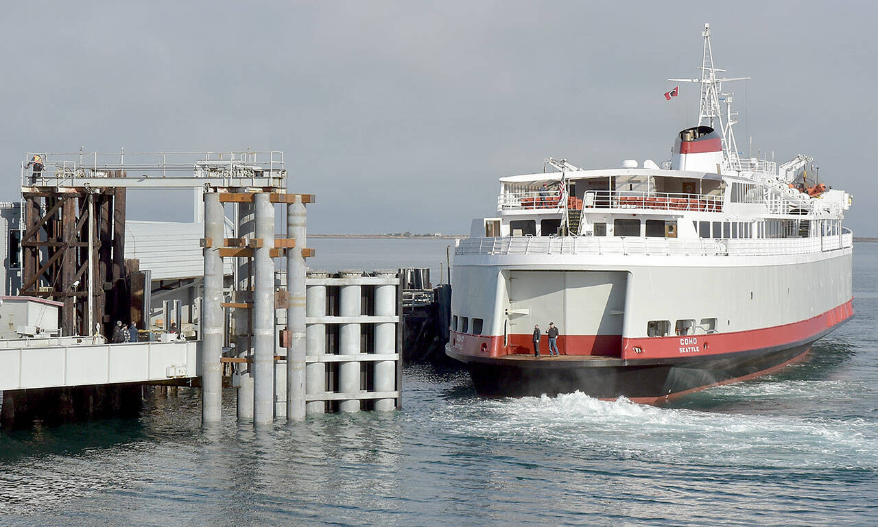 The ferry MV Coho backs into its landing after returning to Port Angeles on Tuesday following annual dry dock and maintenance in Anacortes. During the maintenance period, extensive work was performed on the dock, including replacement of a wing wall used to steer and secure the vessel during loading and unloading of cars and passengers. The ferry is scheduled to resume daily service between Port Angeles and Victoria on Thursday. (Keith Thorpe/Peninsula Daily News)