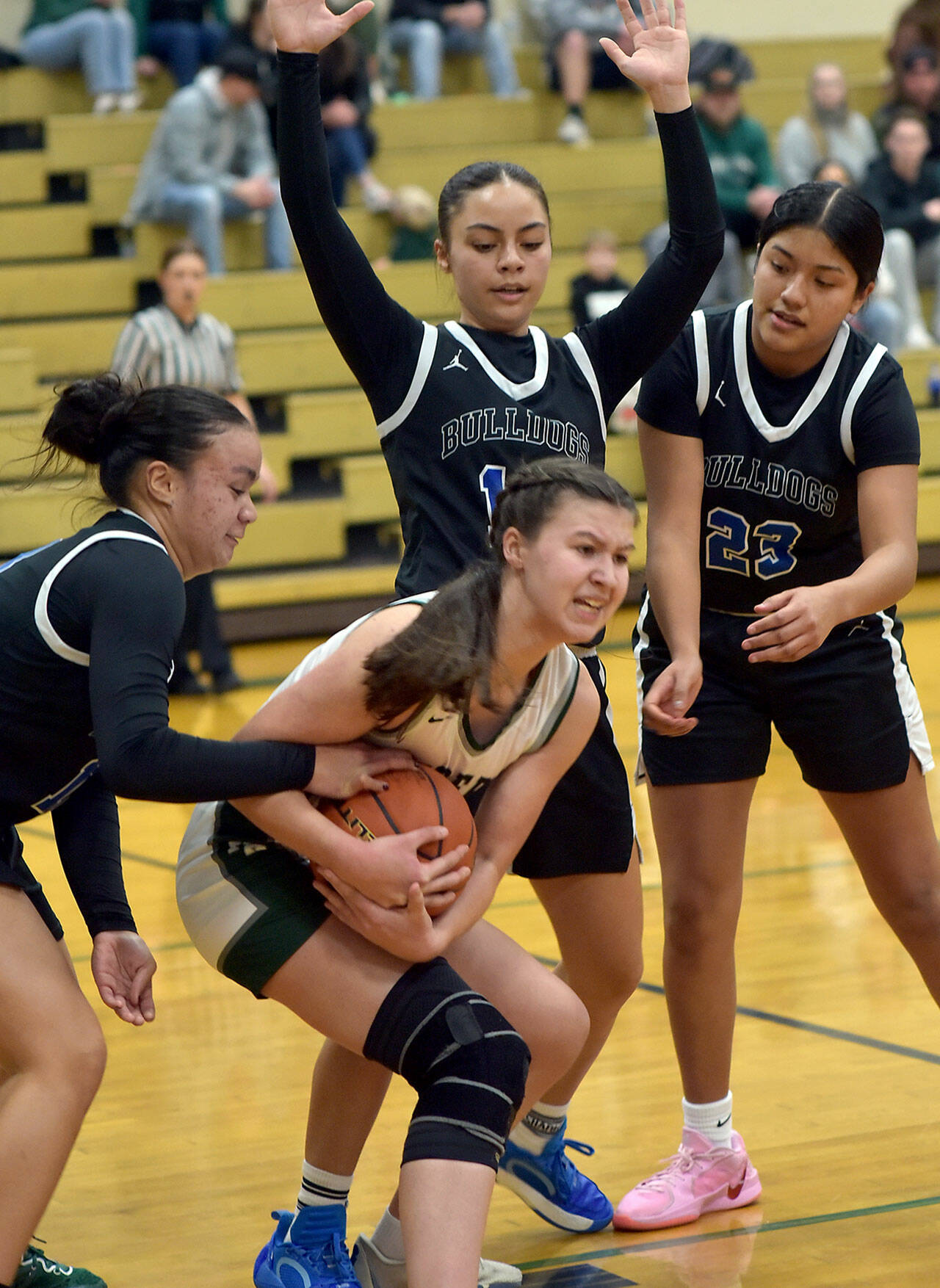 KEITH THORPE/PENINSULA DAILY NEWS Port Angeles’ Lindsay Smith, center, holds onto the ball surrounded by North Mason defenders, from left, Adrianna Tupolo, Adrianne Tupolo and Briana Cauhtenango on Tuesday’s playoff game in Port Angeles.