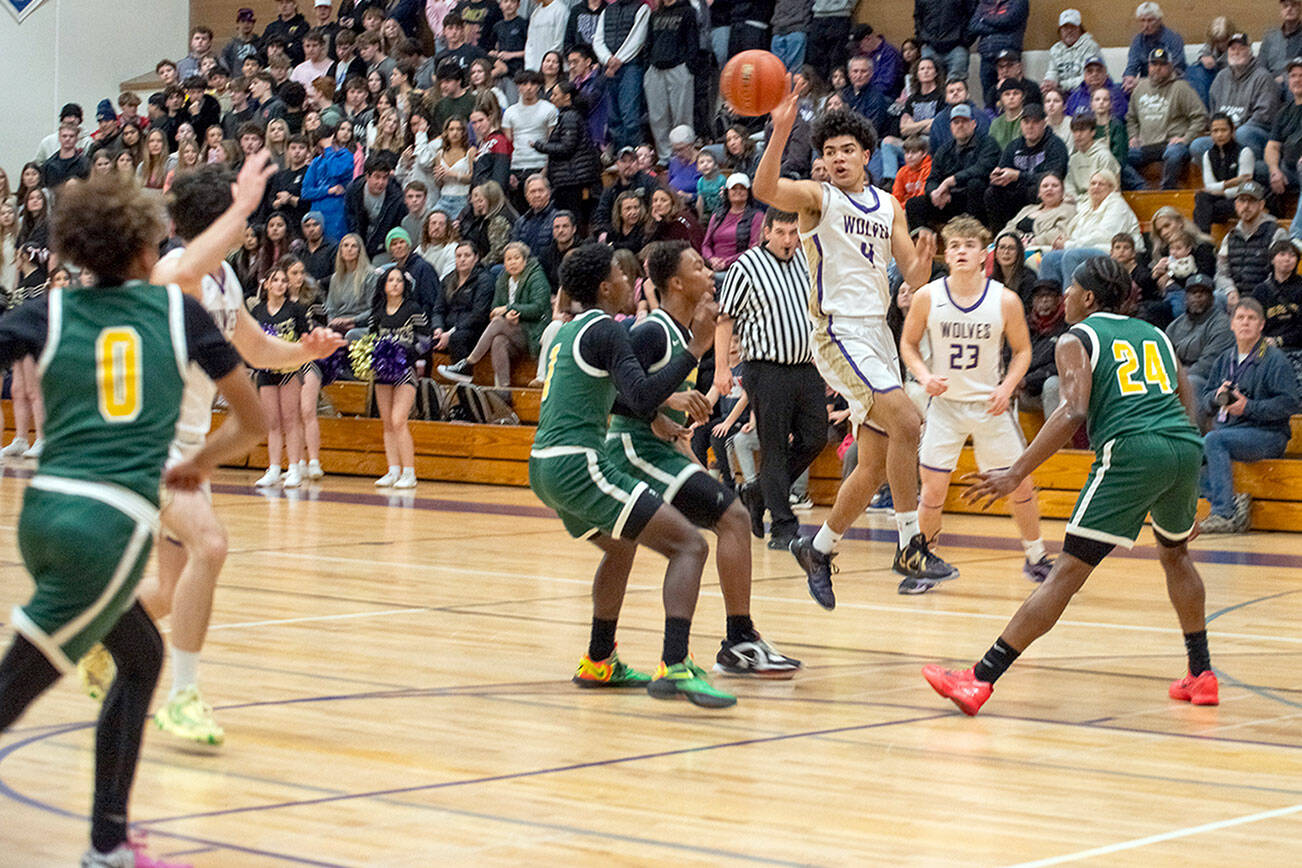 Emily Matthiessen/Olympic Peninsula News Group
Sequim sophomore Jericho Julmist puts up a 3-point shot during the Wolves' 76-50 Class 2A West Central District Boys Basketball Tournament victory Wednesday at Rick Kaps Gym.
