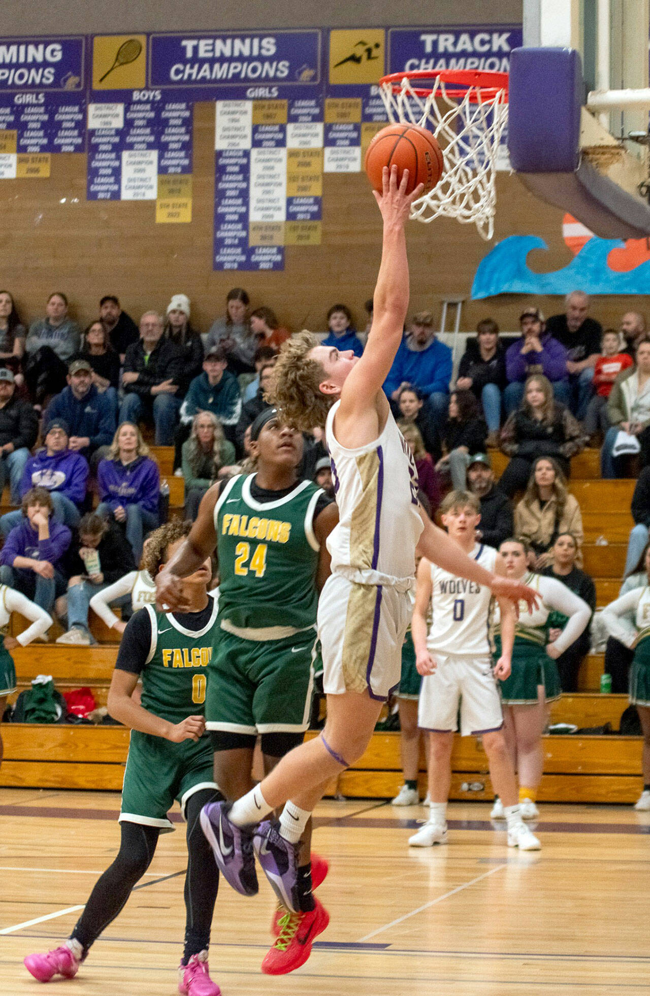 Emily Matthiessen/Olympic Peninsula News Group Sequim’s Zeke Schmadeke puts up a layup while defended by Foss’ Zaire Stubblefield during the Wolves’ 76-50 Class 2A West Central District Boys Basketball Tournament victory Wednesday at Rick Kaps Gym.