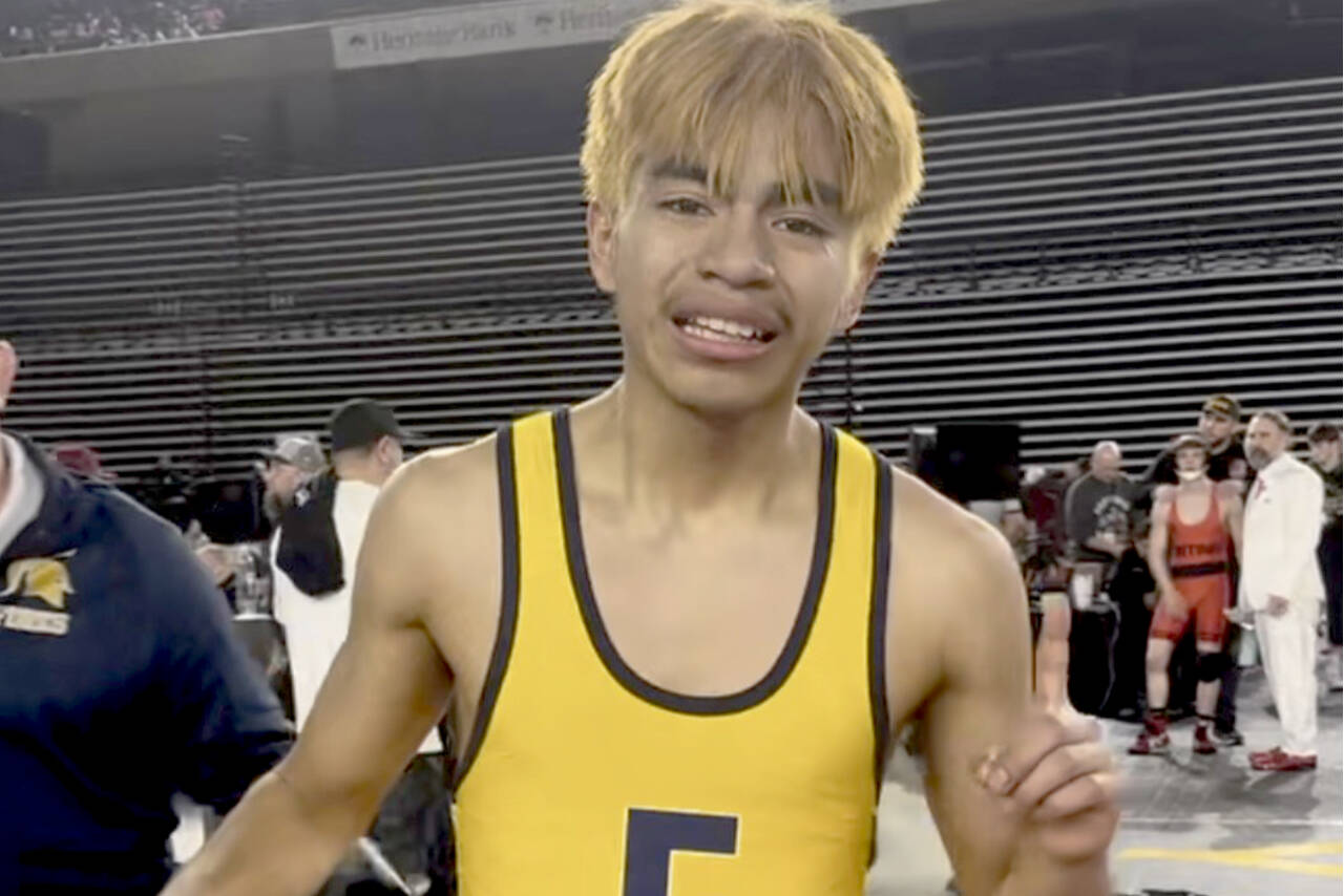 Forks' Abraham Montealegre celebrates his state championship at 110 pounds at the Tacoma Dome on Saturday. Montealegre is part of a long line of Forks state champions in wrestling. (Courtesy of Kyle Weakley)