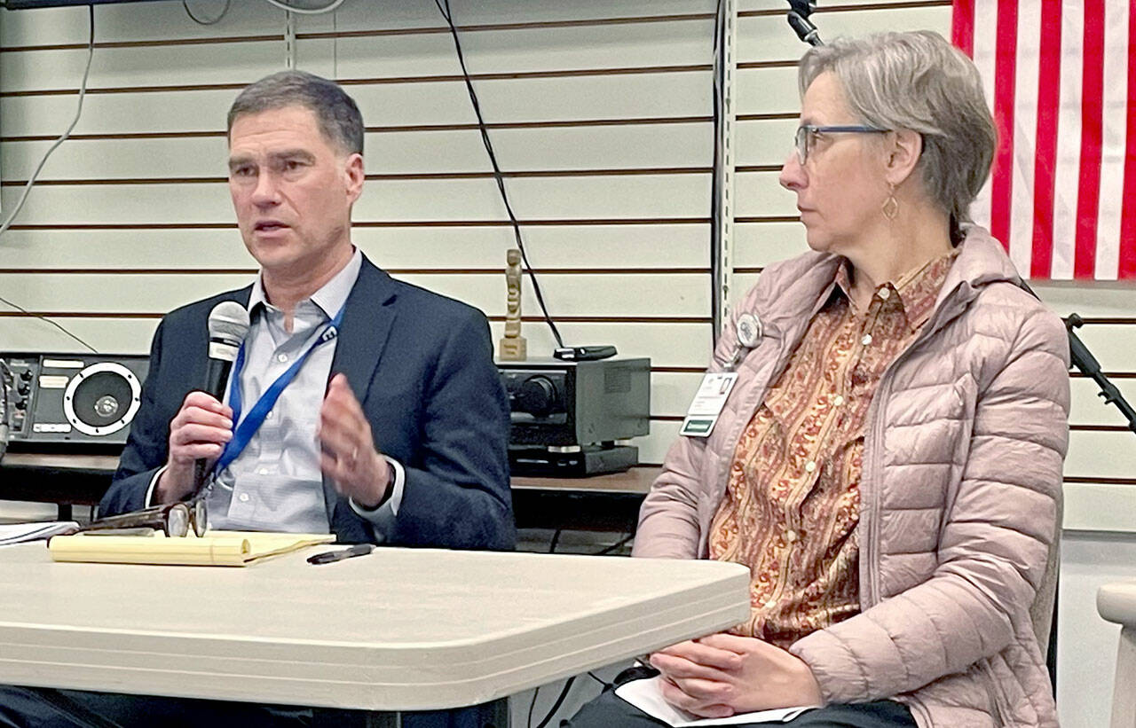 Olympic Medical Center CEO Darryl Wolfe, left, and board President Ann Henninger present information and answer questions about the hospital’s exploration of a possible partnership with another health care system at a forum held by the Clallam County Democrats. Aligning with another organization could help address OMC’s financial challenges and meet community care needs, Wolfe said. (Paula Hunt/Peninsula Daily News)