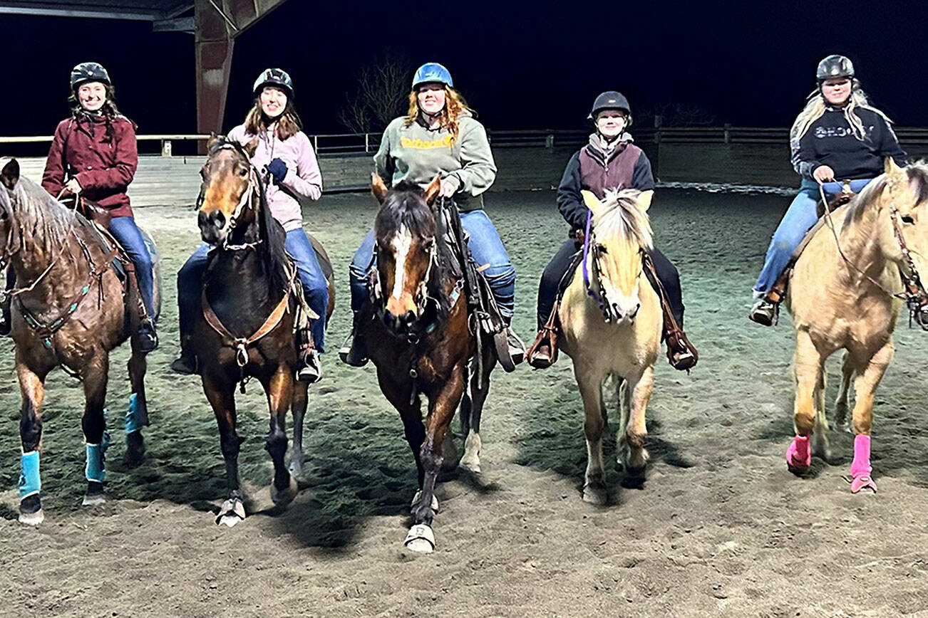 Katie Newton-Salmon
For many years, Freedom Farm owner Mary Gallagher has offered use of her indoor arena, with its mud-free ground, for Sequim and Port Angeles’ equestrian team practices — which is helpful during the cold, dark winter evenings. From left are Kiaja Johnson, Katelynn Middleton-Sharpe, Joanna Seelye, Kenzi, Winters and Savannah Boulton.
