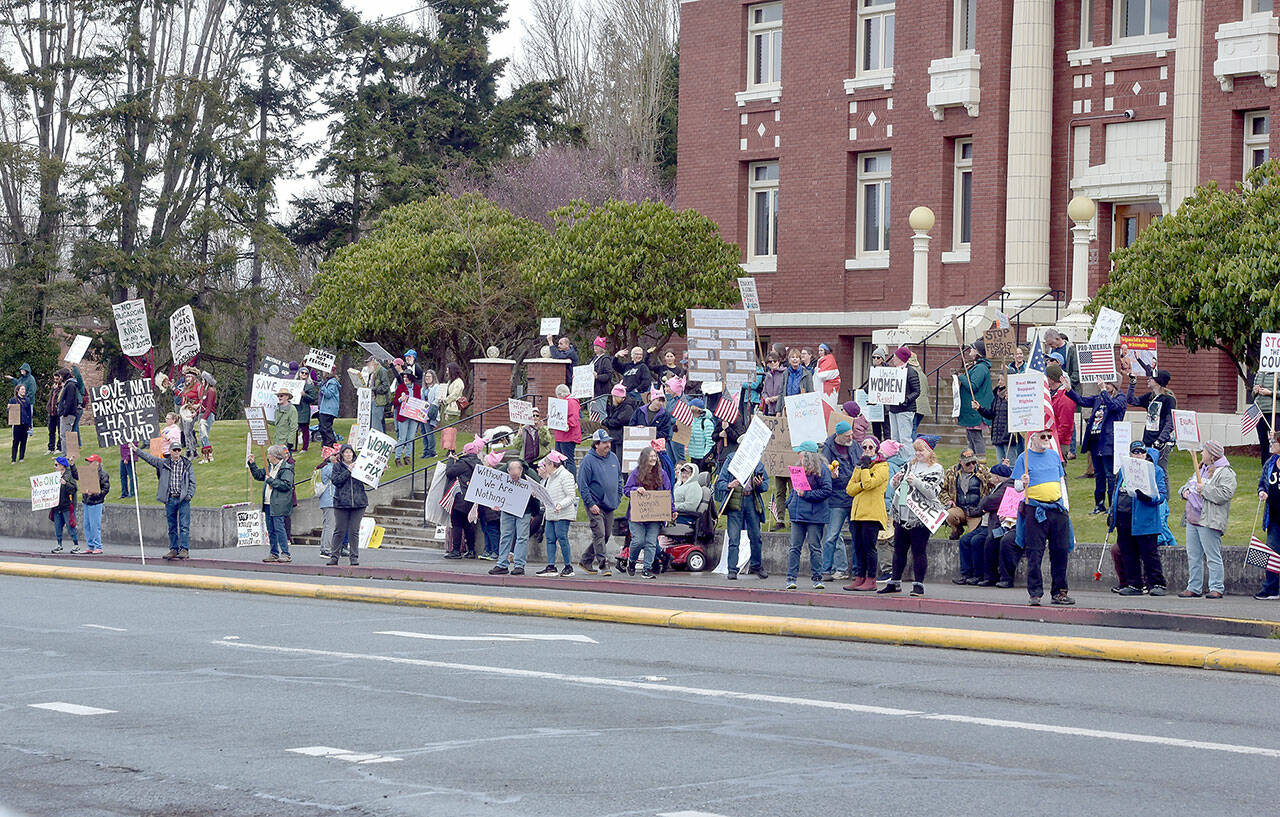 Part of a crowd of nearly 200 people gathers in front of the Clallam County Courthouse in Port Angeles on Saturday for International Women’s Day. The gathering was one of numerous events around the world honoring women and their contributions to global society. (Keith Thorpe/Peninsula Daily News)