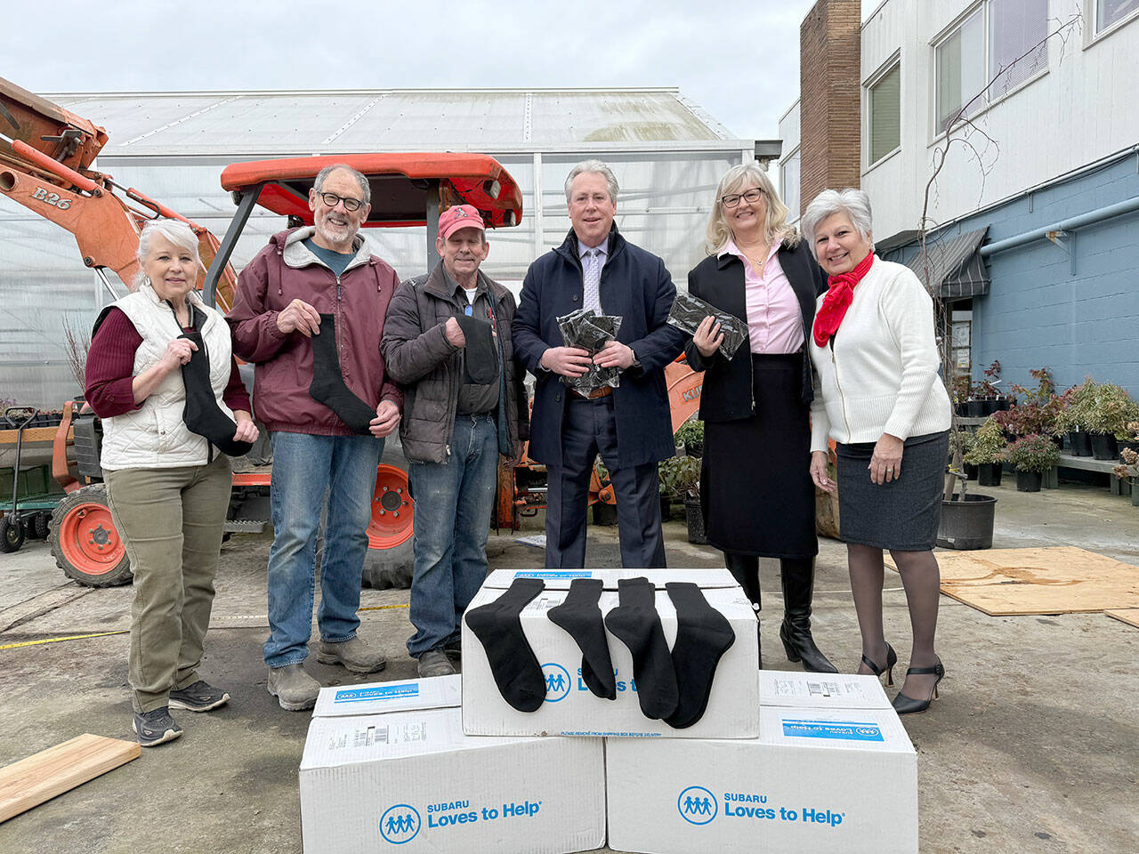 From left: Susan Hillgren, Director of The Answer for Youth, Rotarians Steve Zenovic and Jason Grice working on a project at TAFY along with Bill Koenig, Rotarian and General Manager of Koenig Subaru, Alma Meyrick, Koenig Subaru and Vivian Hansen, Peninsula Daily News.