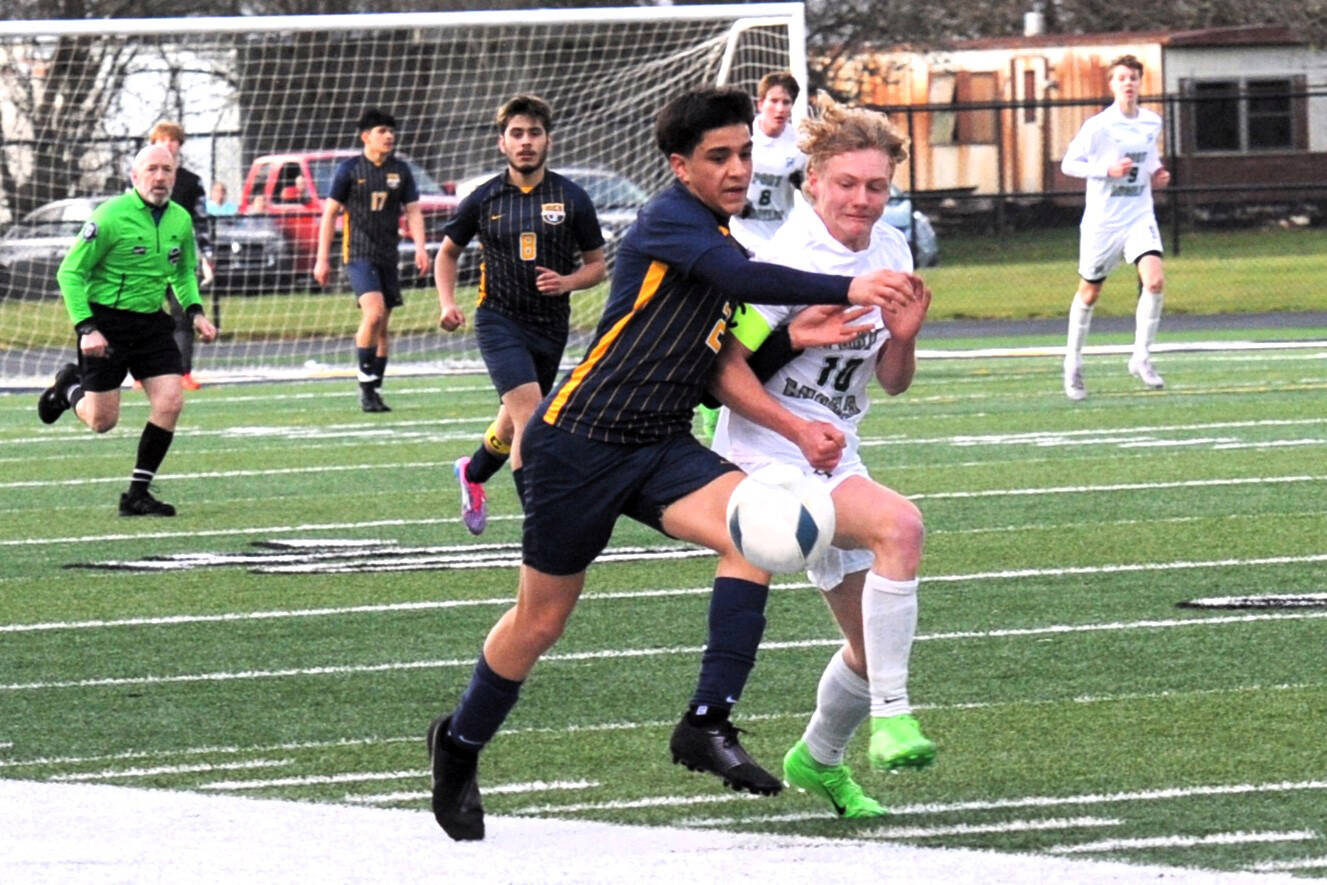 Lonnie Archibald/for Peninsula Daily News
Forks’ Estevan Ramos (2) competes with Port Angeles’ Matthew Miller for the ball on the turf of Spartan Stadium where Port Angeles defeated Forks 2-0.