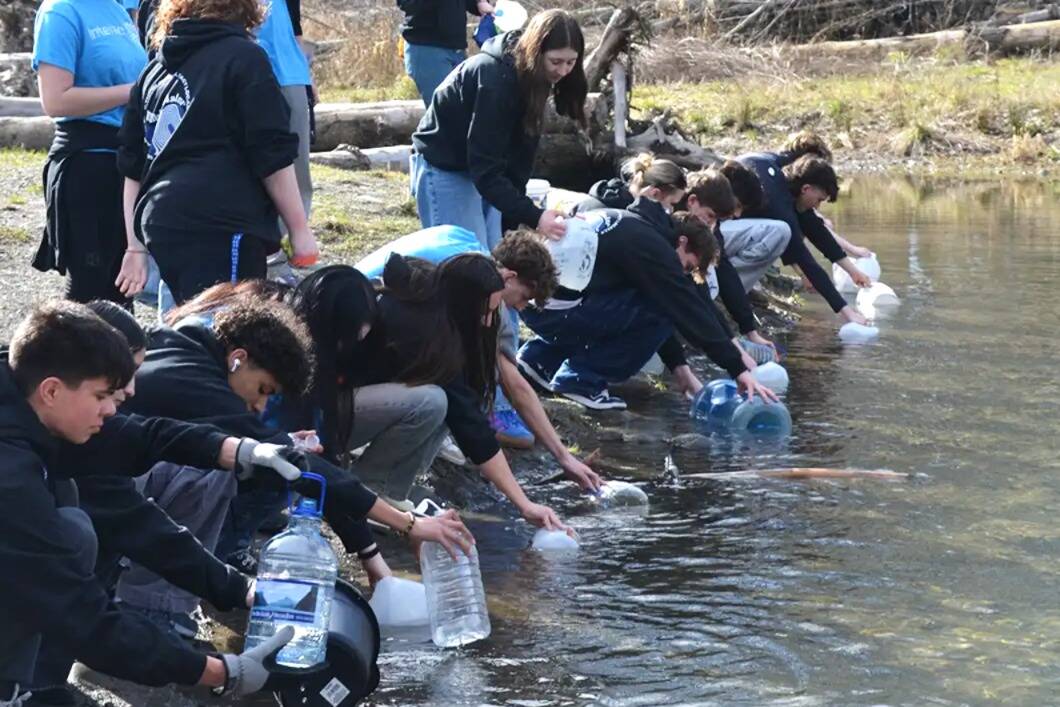 Interact Club members fill jugs and buckets in the Dungeness River for the annual Walk for Water event on March 1. They walk about 4 miles roundtrip to symbolize how far some people must go for drinking water. They raised more than $5,000 to help build a well in a Ghana village. (John Pehrson)
Interact Club members fill jugs and buckets in the Dungeness River for the annual Walk for Water event on March 1. They walk about 4 miles roundtrip to symbolize how far some people must go for drinking water. They raised more than $5,000 to help build a well in a Ghana village. (John Pehrson)