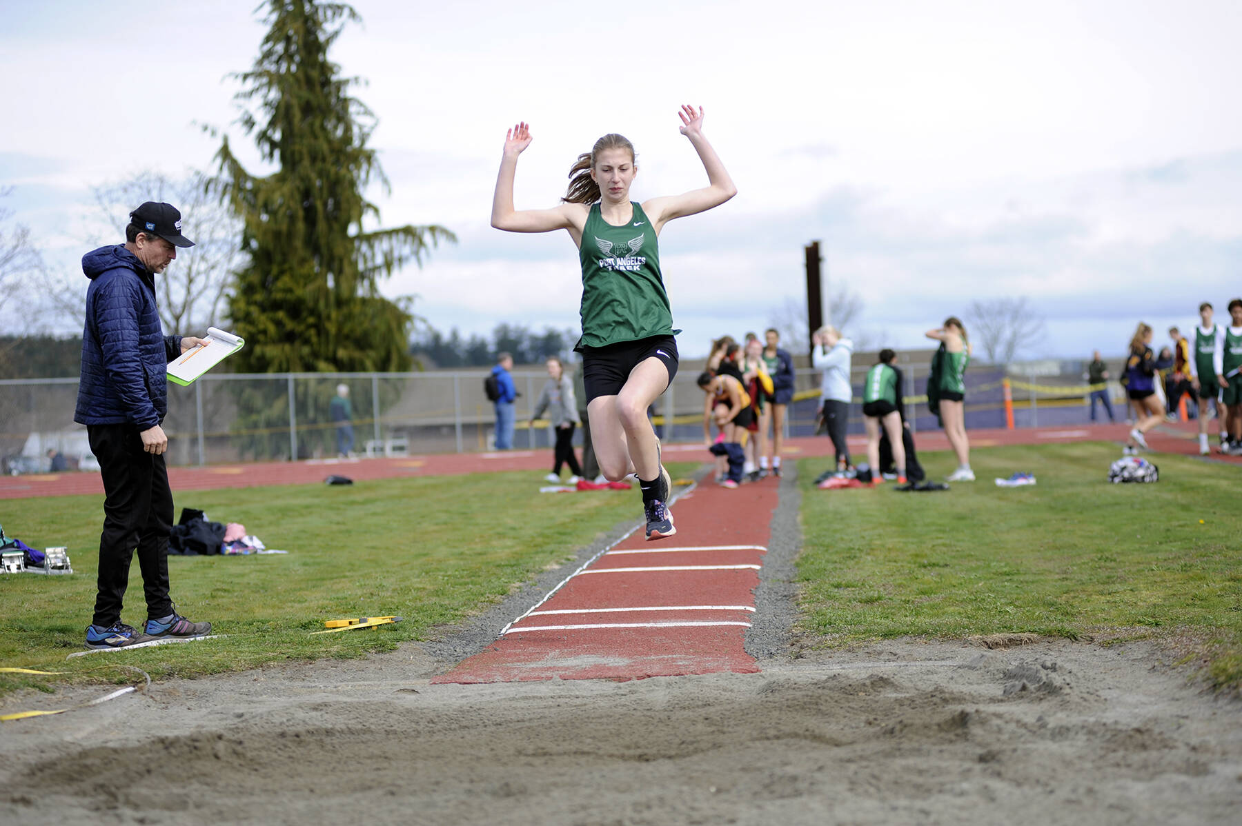 Matthew Nash/Olympic Peninsula News Group 
Port Angeles freshman Madeline Walton competes in the long jump during a track and field meet held at Sequim High School. It was the first meet held on the recently resurfaced track in Sequim since 2021.