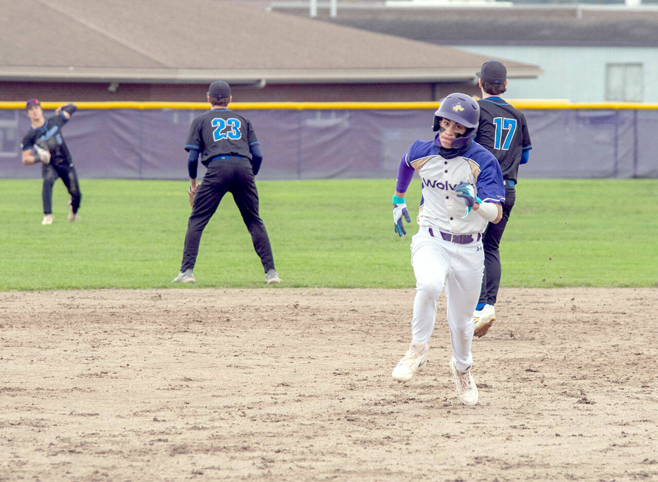 Emily Matthiessen/Olympic Peninsula News Group Sequim’s Bryant LaBoy sprints toward third base while North Mason relays the ball back from the outfield during the Wolves’ 8-7 win on Wednesday.