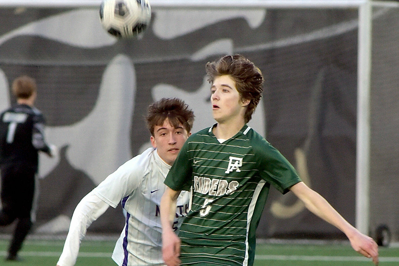 KEITH THORPE/PENINSULA DAILY NEWS
Port Angeles' Harper Willis, right, looks at a loose ball in front of North Kitsap's Gavin Alfonso on Friday at Peninsula College.