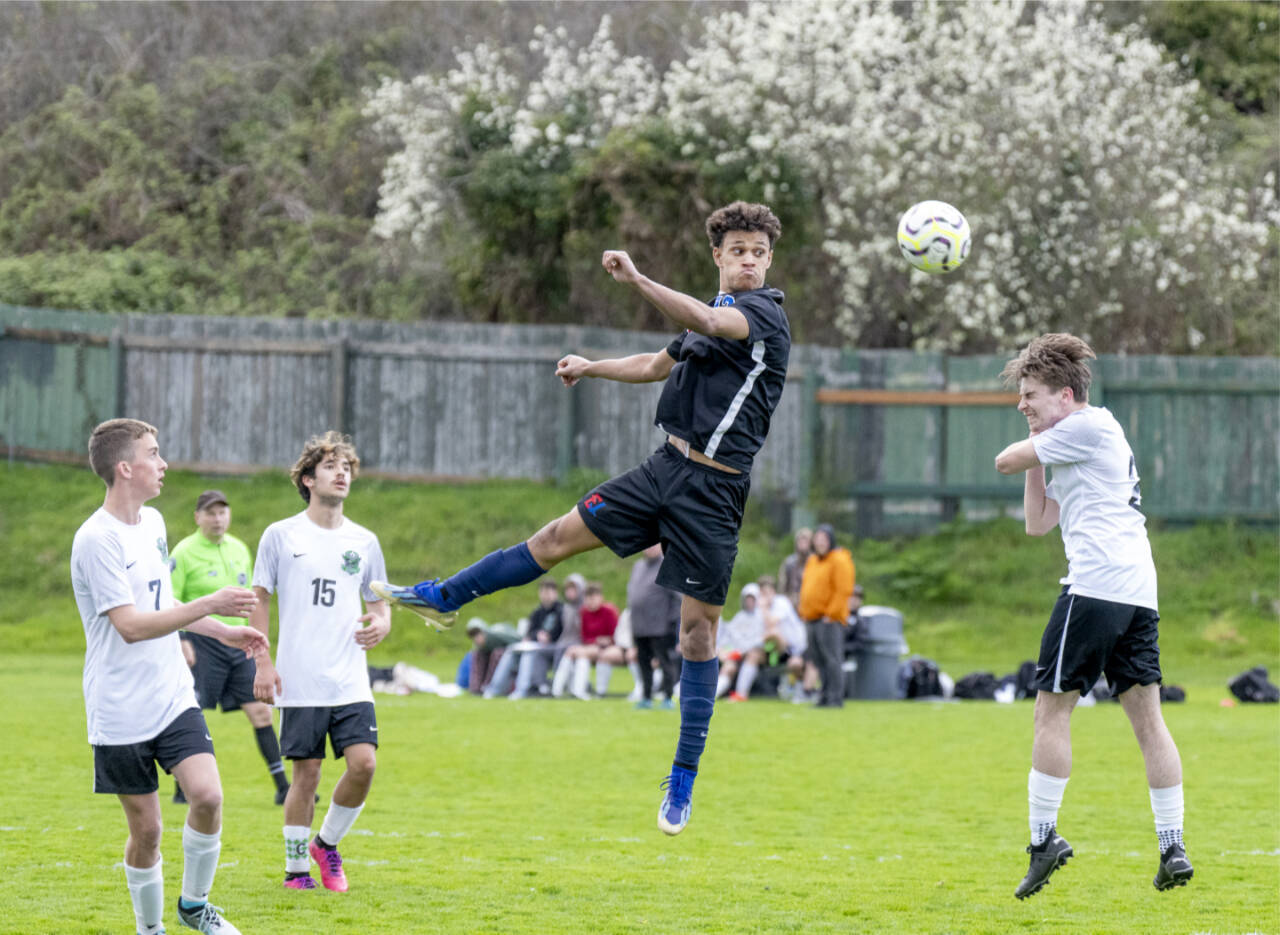 East Jefferson’s Manaseh Lanphear-Ramirez goes airborne to head the ball away from Klahowya defenders during a Nisqually League game played in Port Townsend’s Memorial Stadium on Tuesday. (Steve Mullensky/for Peninsula Daily News)