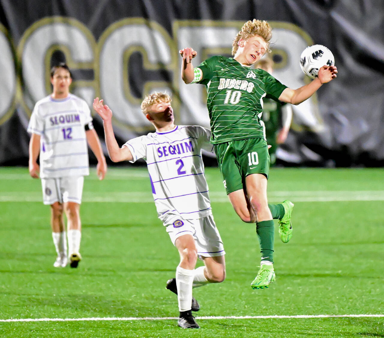 Port Angeles’ Matthew Miller heads the ball at Wally Sigmar Field on Tuesday as Sequim’s Joshua Alcaraz (2) and Preston Kurtze are in on the play. Miller scored two goals in a 2-1 victory. (Jay Cline/for Peninsula Daily News)