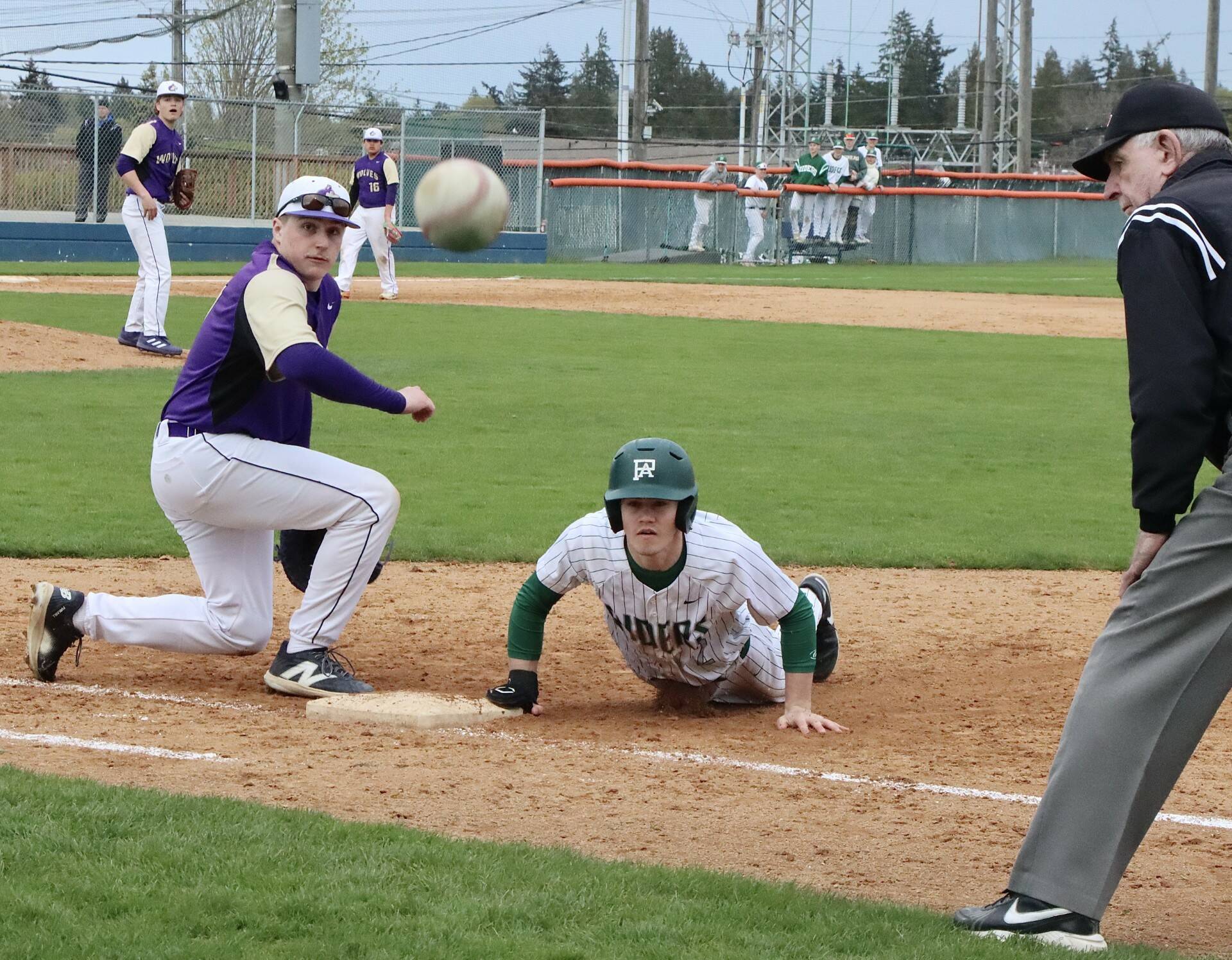 Dave Logan/for Peninsula Daily News
An errant pickoff attempt skipped past Sequim first baseman Braydon White and Port Angeles baserunner Alex Angevine. Angevine advanced to third base on the play, scoring on another throwing error.