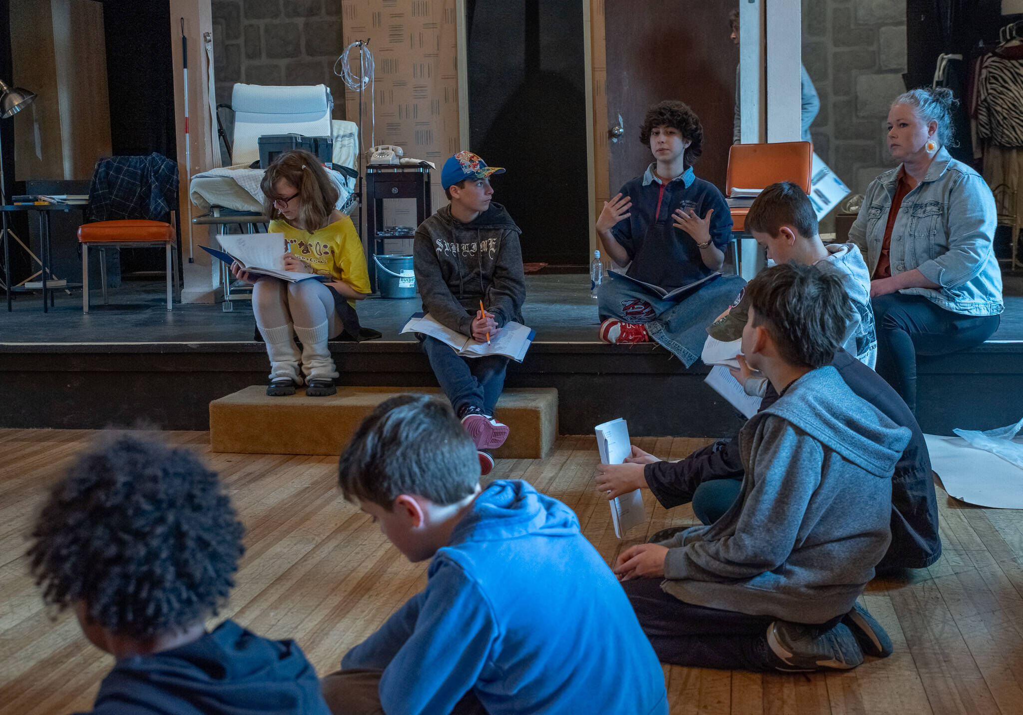 From left to right, student directors Rayna Loree, Paco Struve and Charlie Medlong (mentor Carolyn Edge to the right) coach young thespians during Olympic Theatre Arts’ spring break theater skills program, which culminated in two Saturday performances of “Stones” by playwright Colleen Neuman. (Emily Matthiessen/Olympic Peninsula News Group)