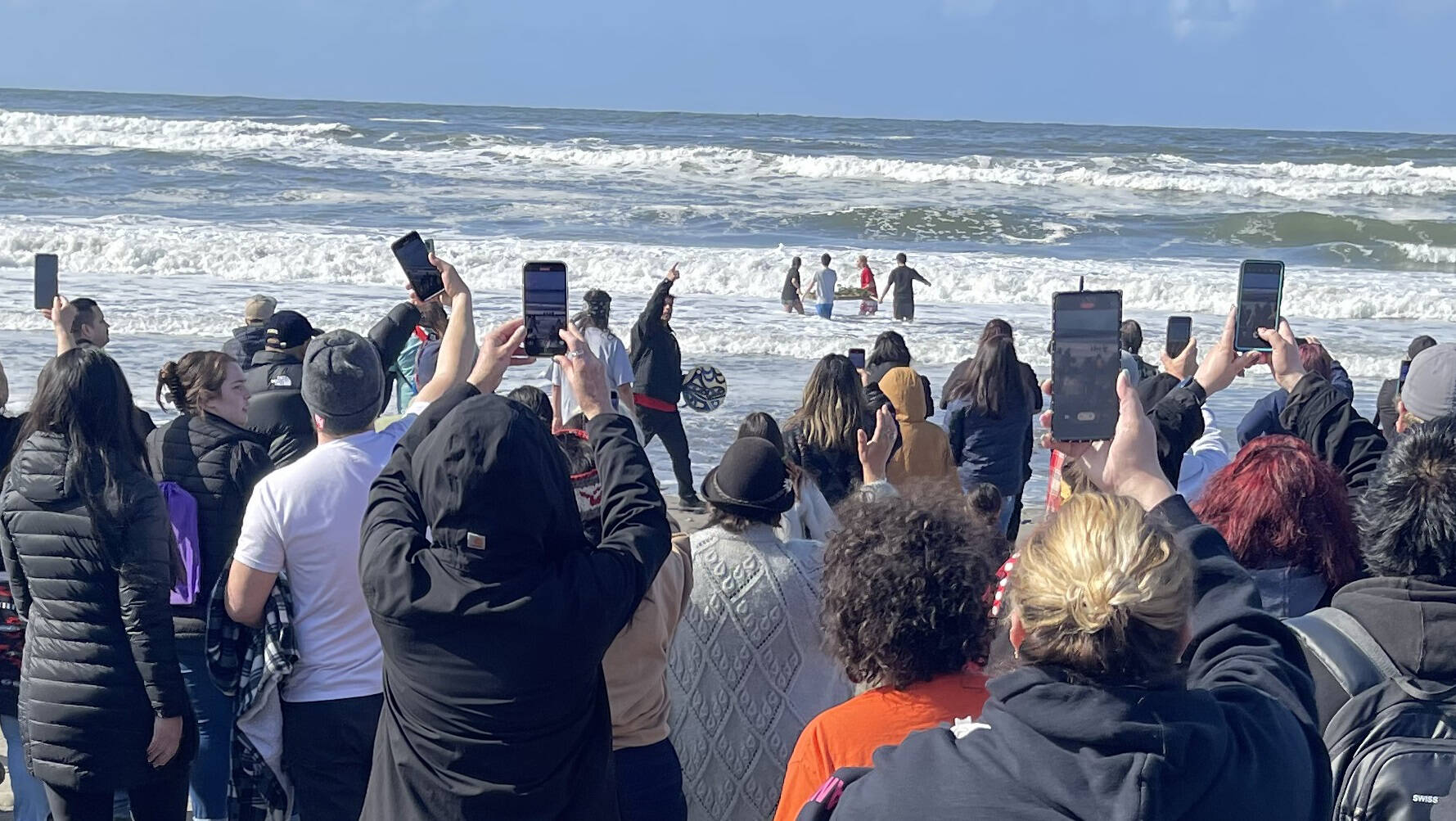 Four Quileute Tribal School students take a salmon offering into the ocean as part of the annual Welcoming the Whales ceremony at First Beach in La Push on Friday. (Christi Baron/Olympic Peninsula News Group)