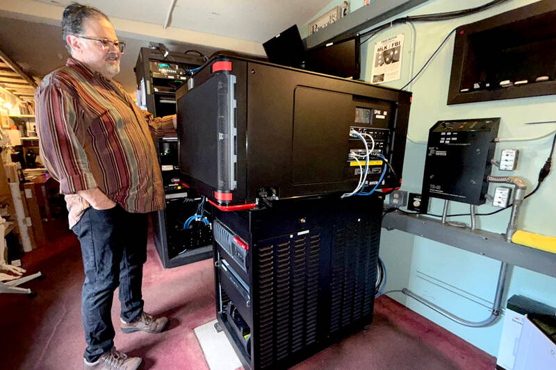 Jason Squire, manager of the Rose Theatre in Port Townsend, shows off the new $150,000 Barco SP4K laser projector installed last month. The projector, one of three that the movie house needs for each of its screens, replaces an aging one that failed in June 2024, necessitating a GoFundMe drive for the owners, George Marie and Michael D’Alessandro, to help pay for a new one. More than $105,000 was raised from 777 donors. (Steve Mullensky/for Peninsula Daily News)