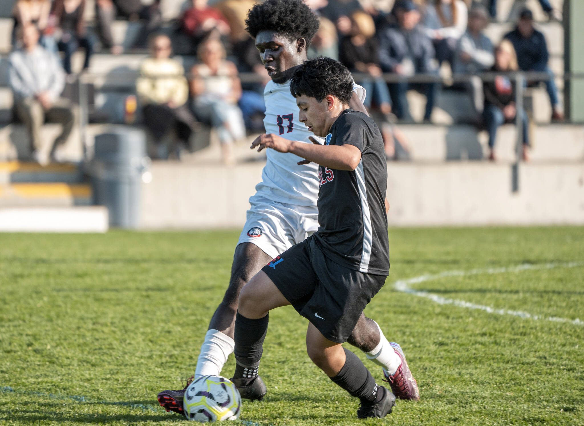 Steve Mullensky/for Peninsula Daily News 
East Jefferson’s Alan Morales dribbles while defended by Life Christian’s Isaiah Ssemmanda at Memorial Field on Thursday.