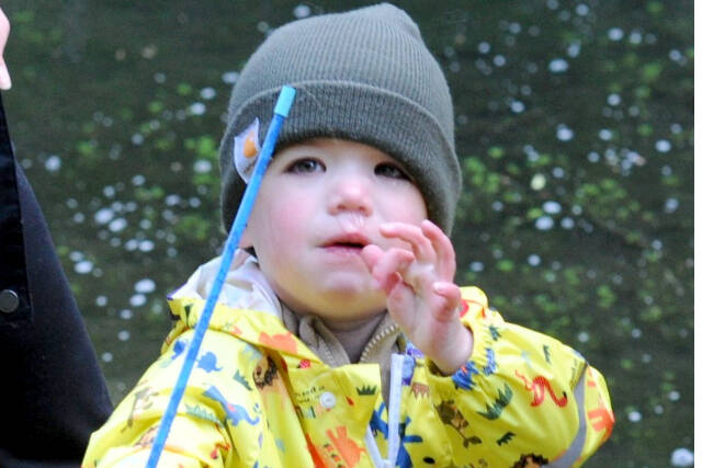 Two-year-old Cole Johanson makes a final adjustment to his line and lure before casting into the Bogachiel Rearing Pond on Sunday during the annual Kids Fish Day in Forks. About 180 kids 12 and under participated in the fishing fun sponsored by the West End Sportsmen's Club.  The Forks Elks Lodge provided complimentary hotdogs, cocoa, donuts and coffee. (Lonnie Archibald/for Peninsula Daily News)