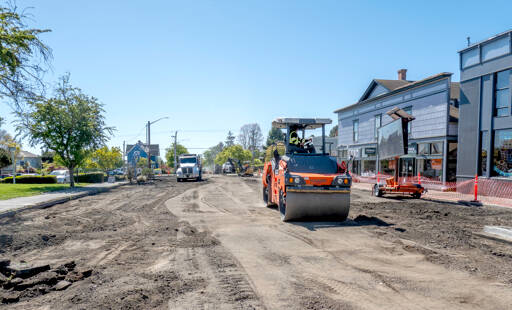 A road roller from Northern Asphalt compacts the dirt on Tyler Street in Uptown Port Townsend. The asphalt work may be finished by today to allow for striping so the street will be open in time for Saturday’s Farmers Market. (Steve Mullensky/for Peninsula Daily News)