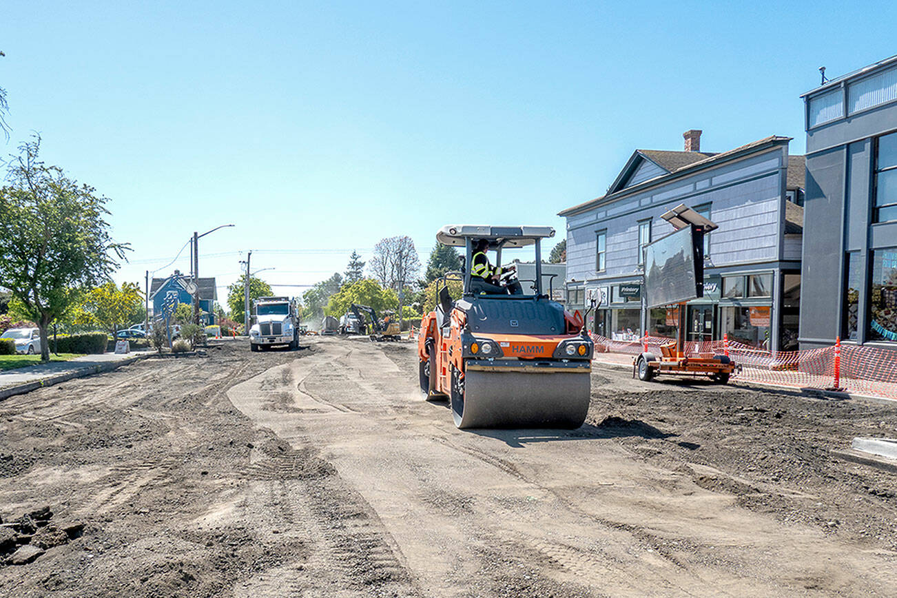 A road roller from Northern Asphalt compacts the dirt on Tyler Street in Uptown Port Townsend on Monday. The asphalt work may be finished by Wednesday to allow for striping so the street will be open in time for Saturday’s Farmers Market. (Steve Mullensky/for Peninsula Daily News)