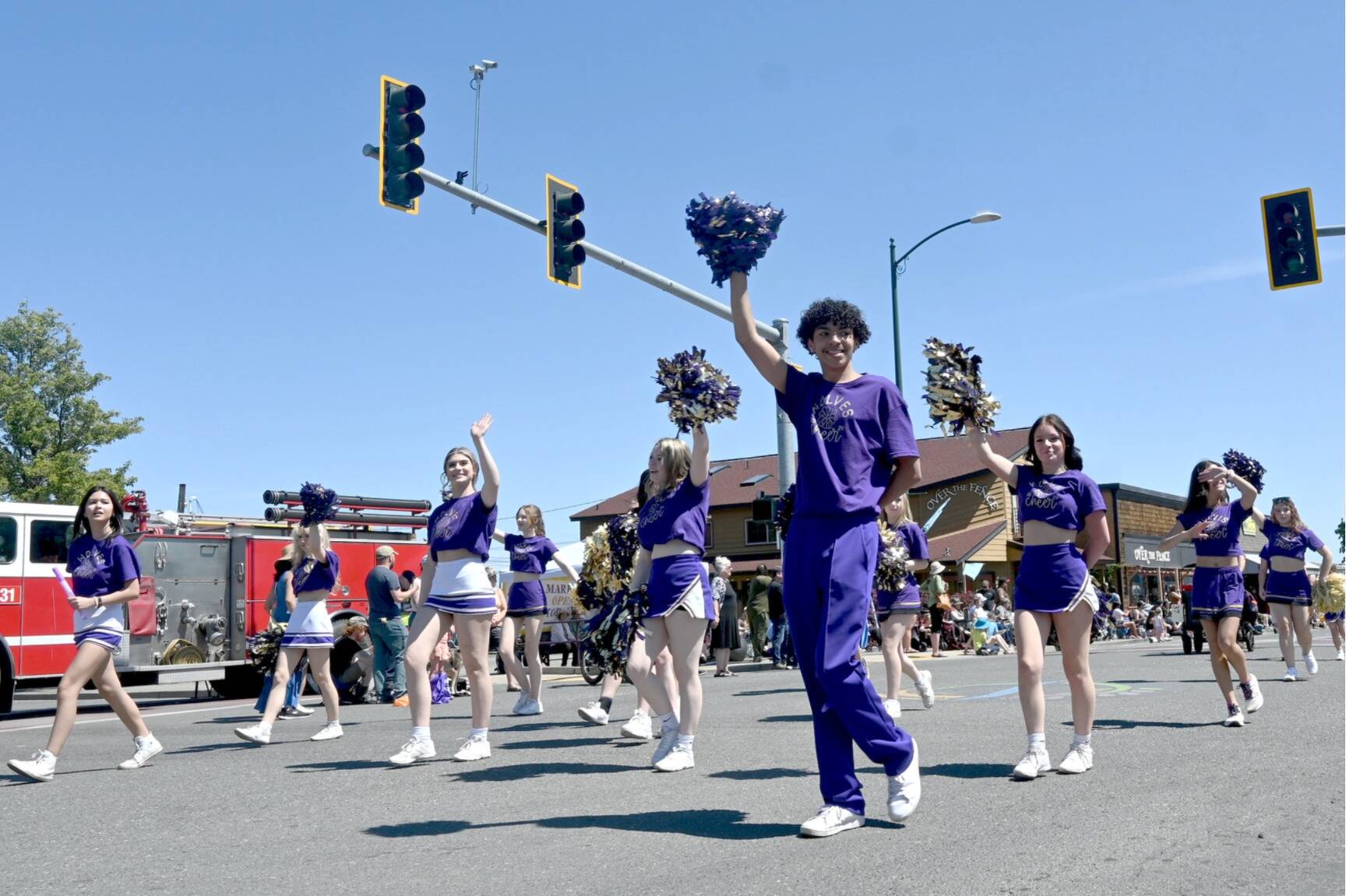 Sequim High School’s cheerleaders wave to the crowd at last year’s Sequim Irrigation Festival Grand Parade. Organizers said at least 110 entries will return for Saturday’s event, which is set to begin at noon. (Michael Dashiell/Olympic Peninsula News Group file)