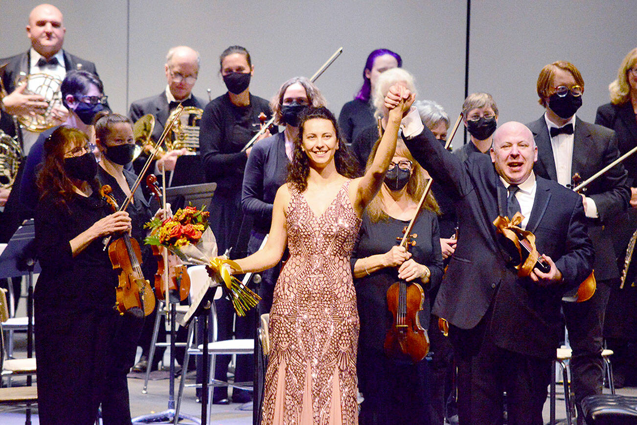 Port Angeles Symphony Conductor Jonathan Pasternack, guest soloist Anna Petrova and the orchestra celebrate their return to the stage in November 2021. (Diane Urbani de la Paz/for Peninsula Daily News)