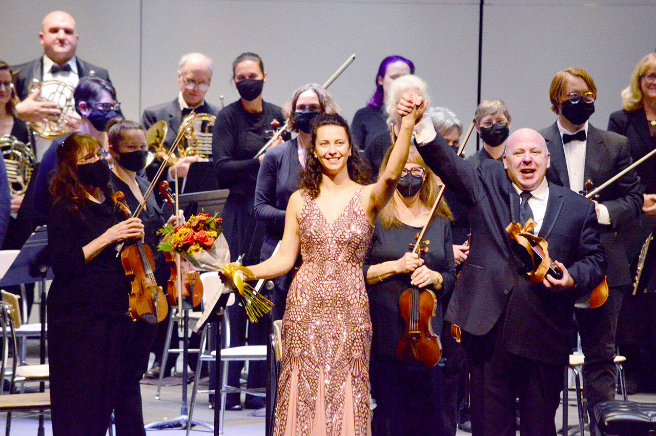 Port Angeles Symphony Conductor Jonathan Pasternack, guest soloist Anna Petrova and the orchestra celebrate their return to the stage in November 2021. (Diane Urbani de la Paz/for Peninsula Daily News)