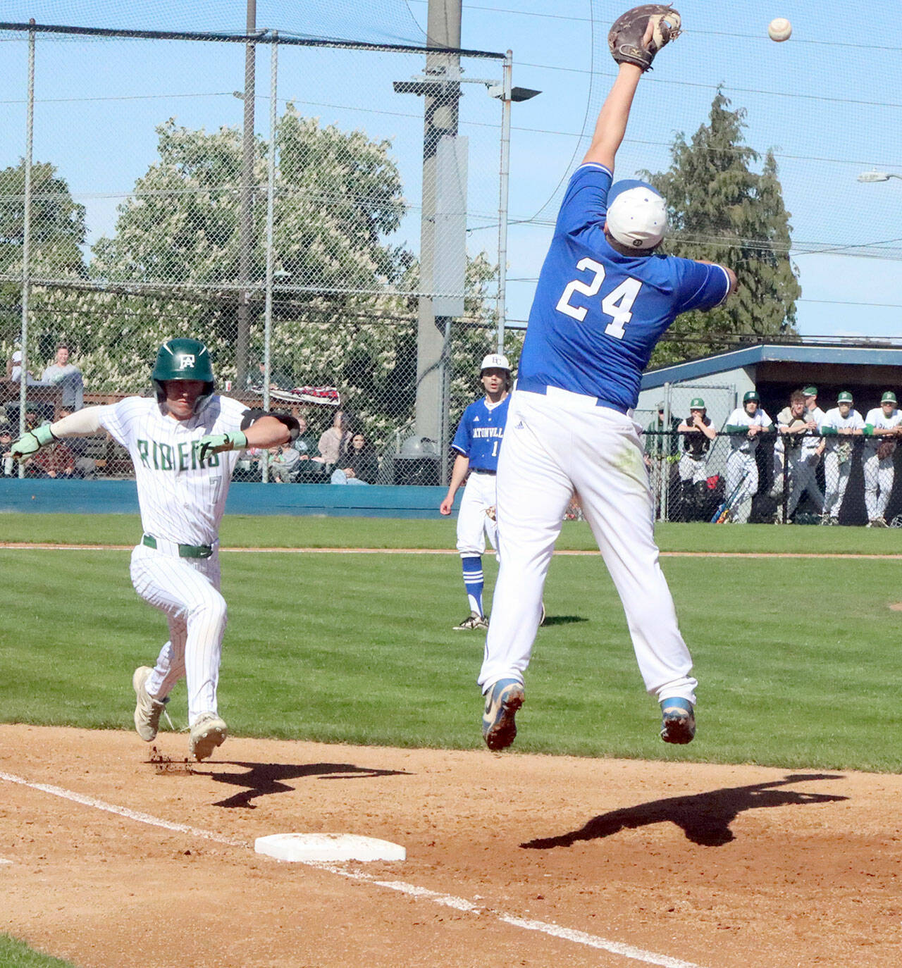 Port Angeles’ Ian Smithson reaches first baseball safely as the throw to the Eatonville first baseman was high and pulled him off the bag. Port Angeles won 8-1 to stay alive in the District 3 tournament. (Dave Logan/for Peninsula Daily News)