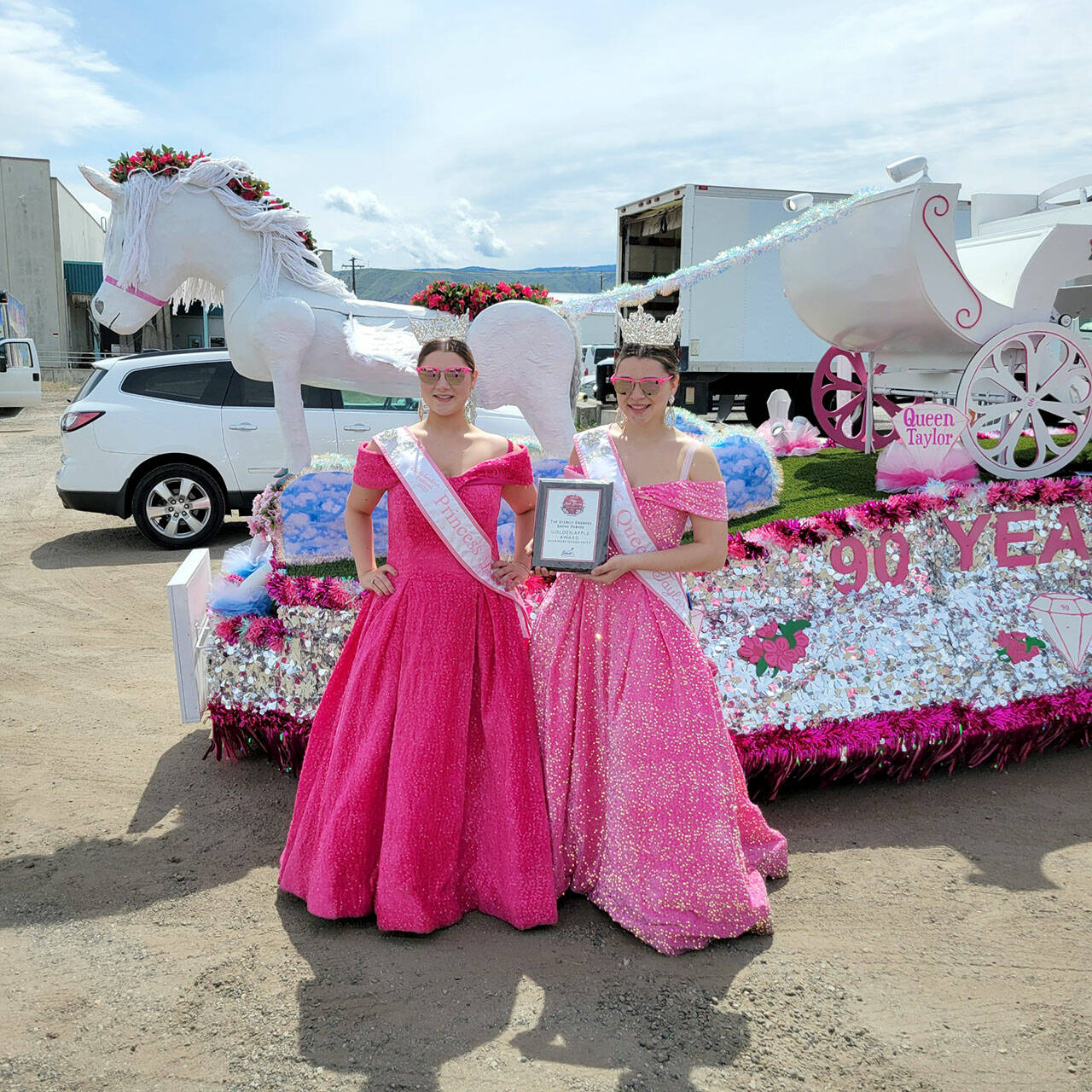 Rhody Princess Lorelei Turner, left, and Rhody Queen Taylor Frank at the Washington State Apple Blossom Festival in Wenatchee, where they received the Golden Apple award. (Lori Morris)