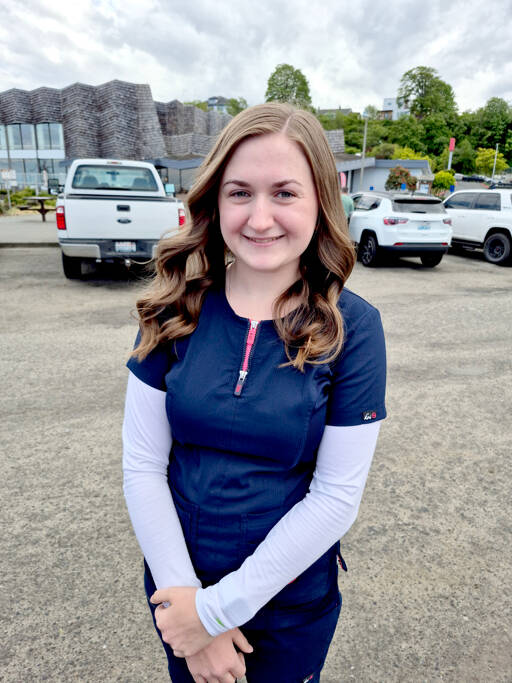 Kaylee Oldemeyer, a second-year nursing student, is among those selling tickets for the Great Olympic Peninsula Duck Derby this Sunday. (Leah Leach/for Peninsula Daily News)